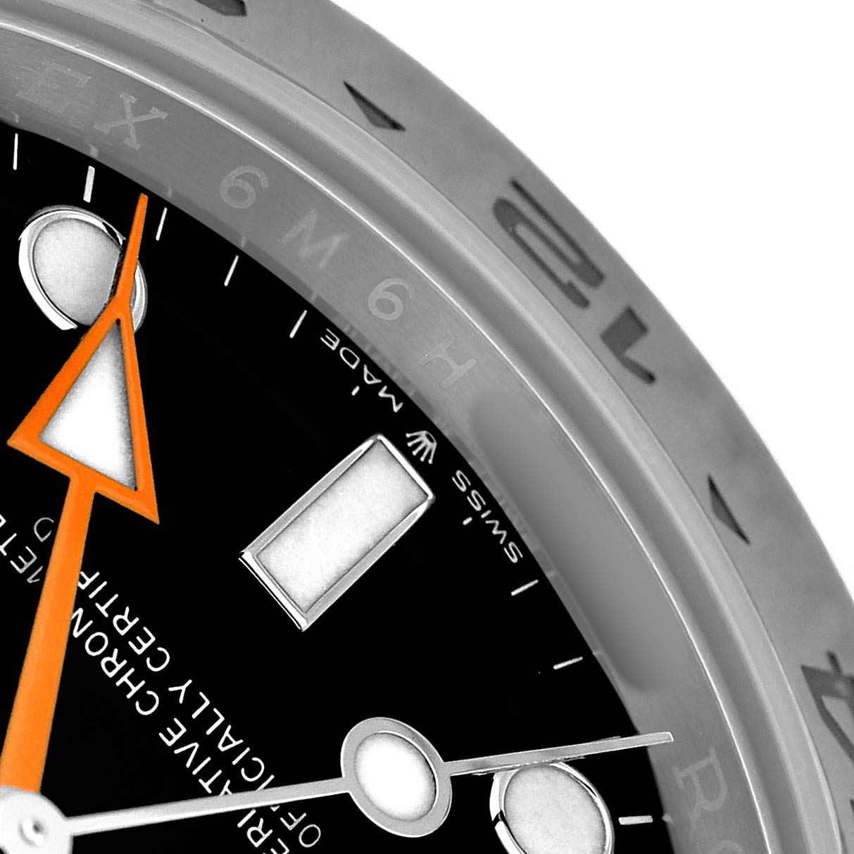 The image shows a close-up of the Rolex Explorer 226570 Men's Stainless Steel Black Dial watch face, highlighting the orange hand, hour markers, and part of the bezel.