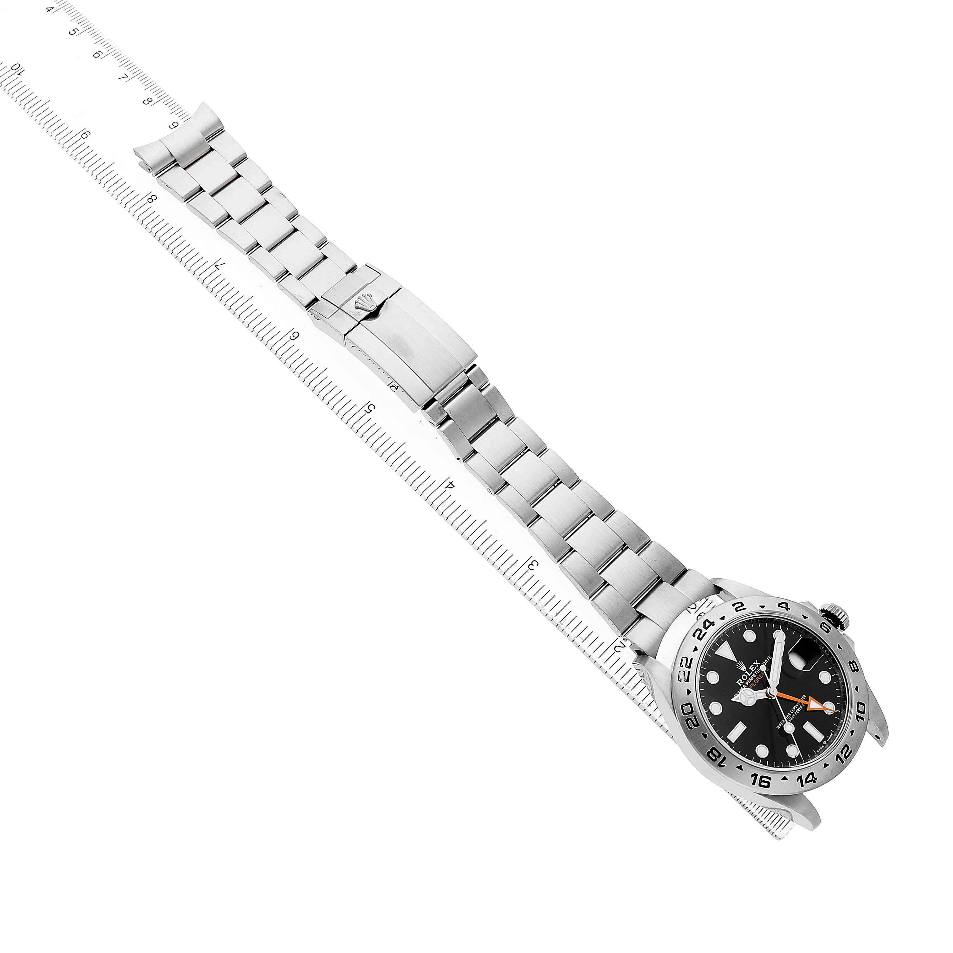 The Rolex Explorer 226570 Men's Stainless Steel Black Dial watch is shown from an overhead angle, displaying the face, bezel, bracelet, and clasp.