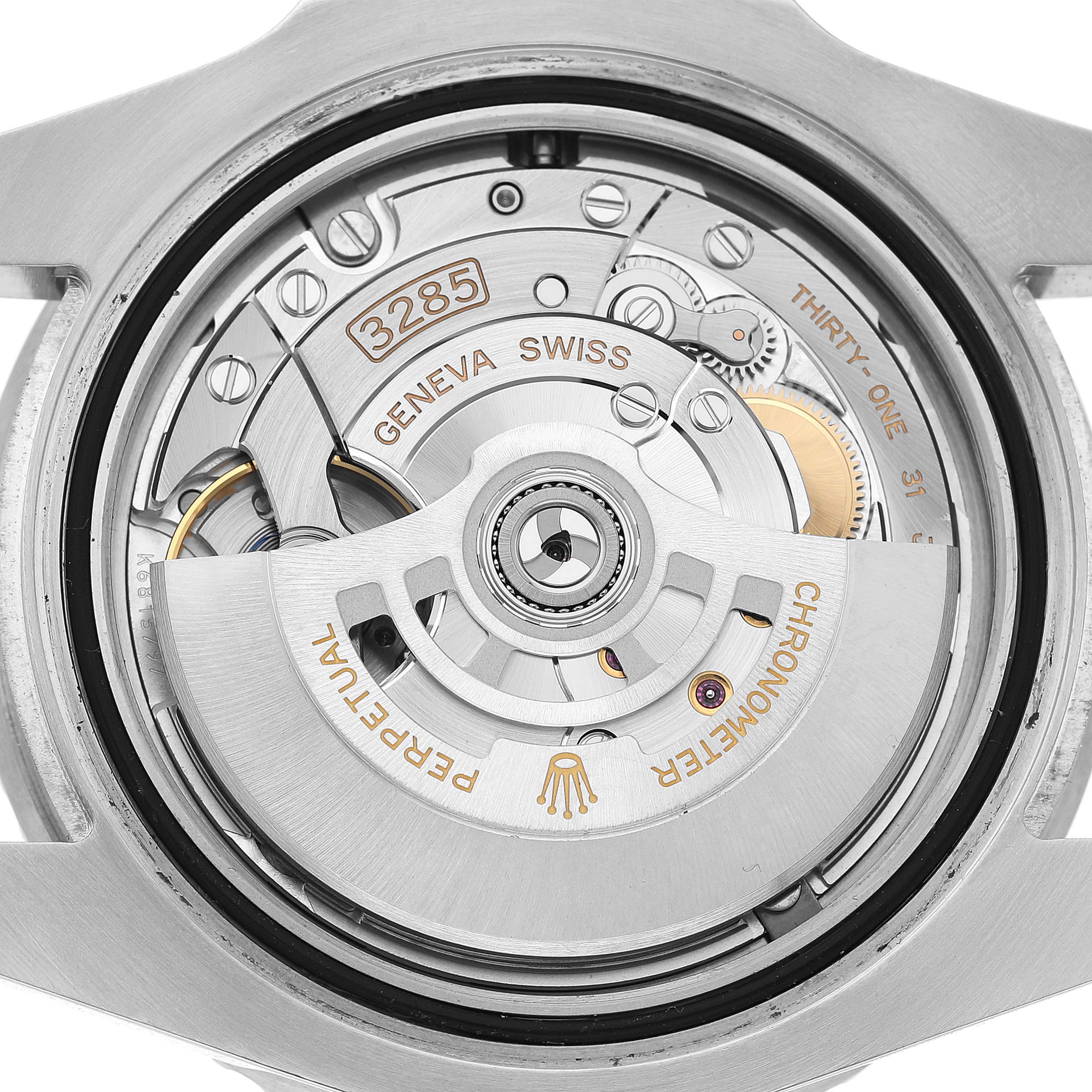 The image shows the movement of a Rolex GMT-Master 126720VTNR Men's Stainless Steel Black Dial, with the rotor and intricate mechanical parts visible.