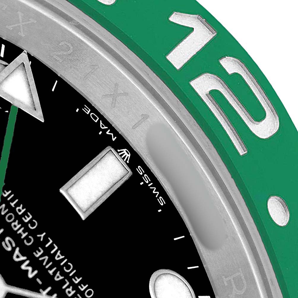 The image shows a close-up of the bezel and part of the dial of a Rolex GMT-Master 126720VTNR Men's Stainless Steel Black Dial, highlighting the green color and hour markers.