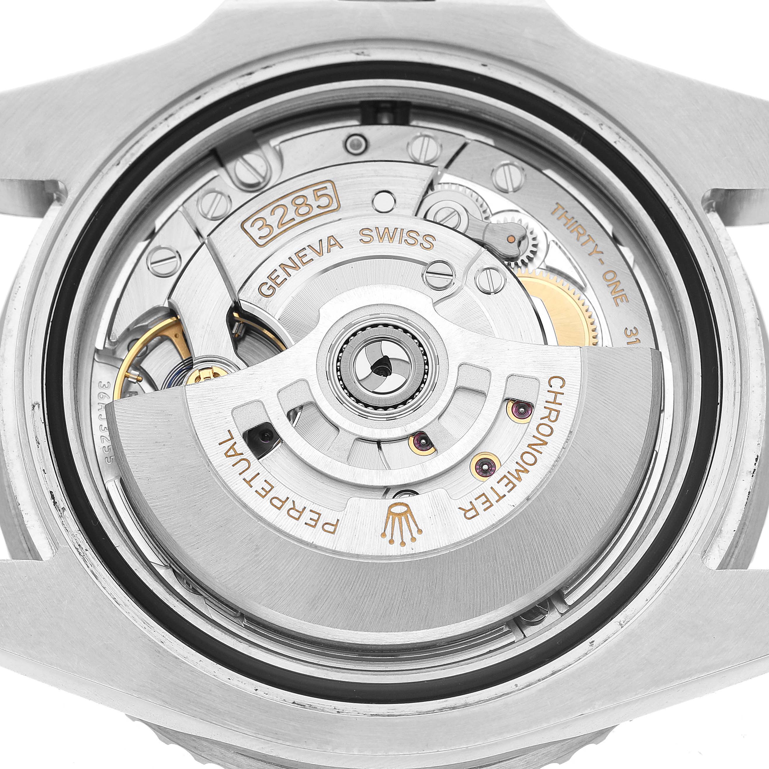 The image shows the exposed movement of a Rolex GMT-Master 126720VTNR Men's Stainless Steel Black Dial, focusing on the rotor and internal mechanics.