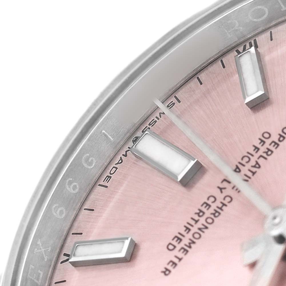 This close-up angle shows the dial and indices of a Rolex Oyster Perpetual 124200 Men's Stainless Steel Pink Dial, featuring a pink face and part of the bezel.
