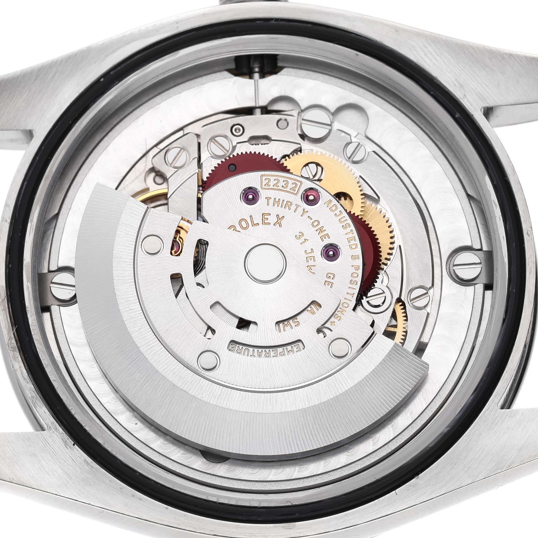 The image shows the Rolex Oyster Perpetual 124200 Men's Stainless Steel Pink Dial's movement from a top-down angle, highlighting gears and the rotor.