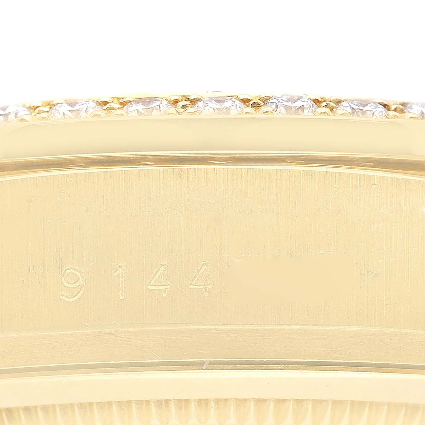 This image shows a close-up of the side engraving and diamond bezel of a Rolex President 18048A Men
s Yellow Gold Champagne Dial 18048A Men
s Yellow Gold Champagne Dial model watch.