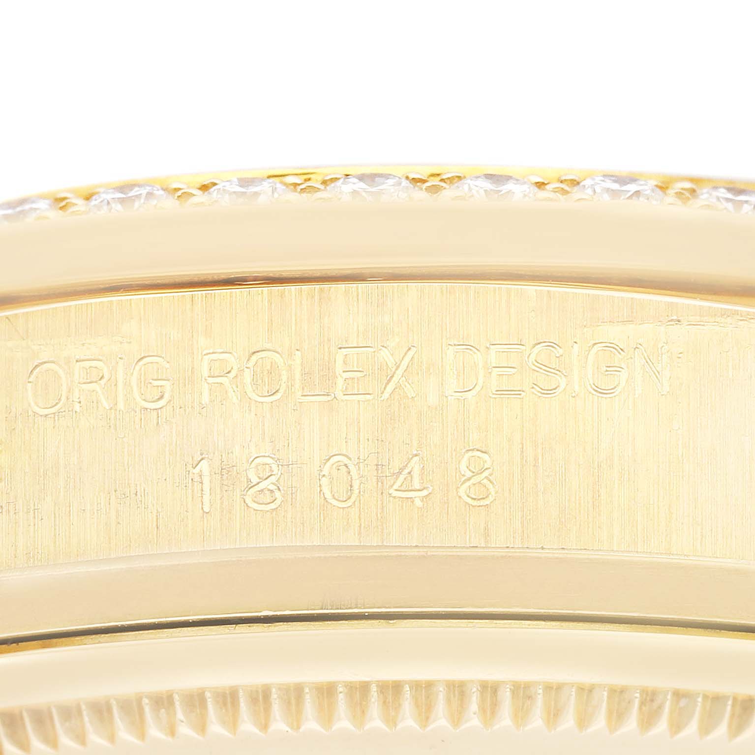 The image shows a close-up of the side of a Rolex President 18048A Men
s Yellow Gold Champagne Dial 18048A Men
s Yellow Gold Champagne Dial watch, focusing on the engraved design and model number 18048.