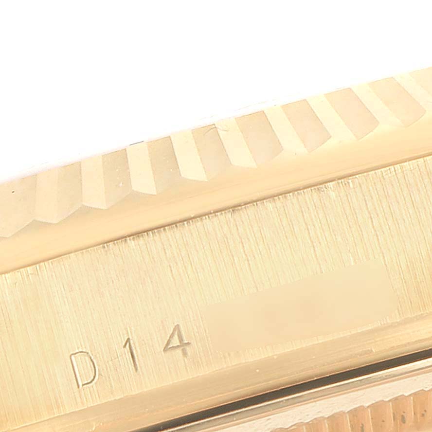 This image shows the engraved edge of a Rolex President 118238 Men
s Yellow Gold Black Dial 118238 Men
s Yellow Gold Black Dial model watch at a close-up angle.