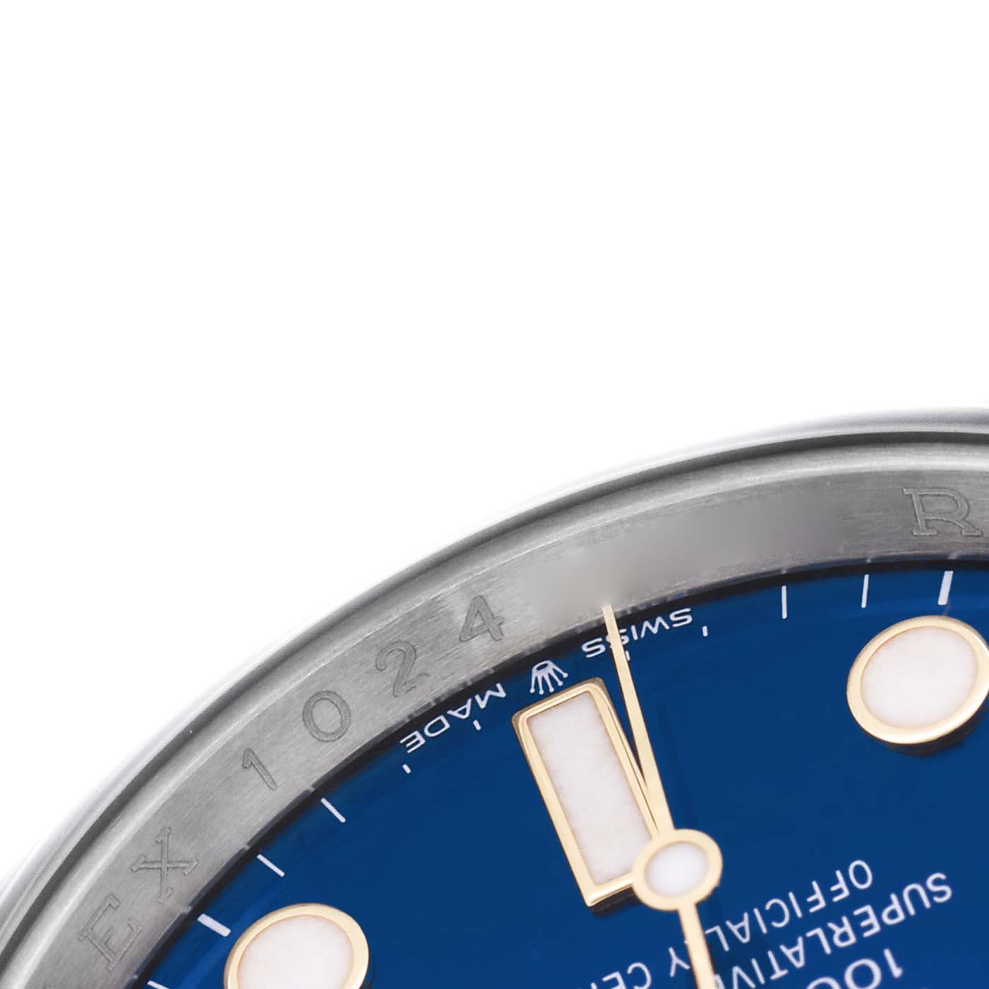 The image shows a close-up of the Rolex Submariner 126613 Men's Steel and Gold (two tone) Blue Dial's dial edge, bezel, and hands at an angle.