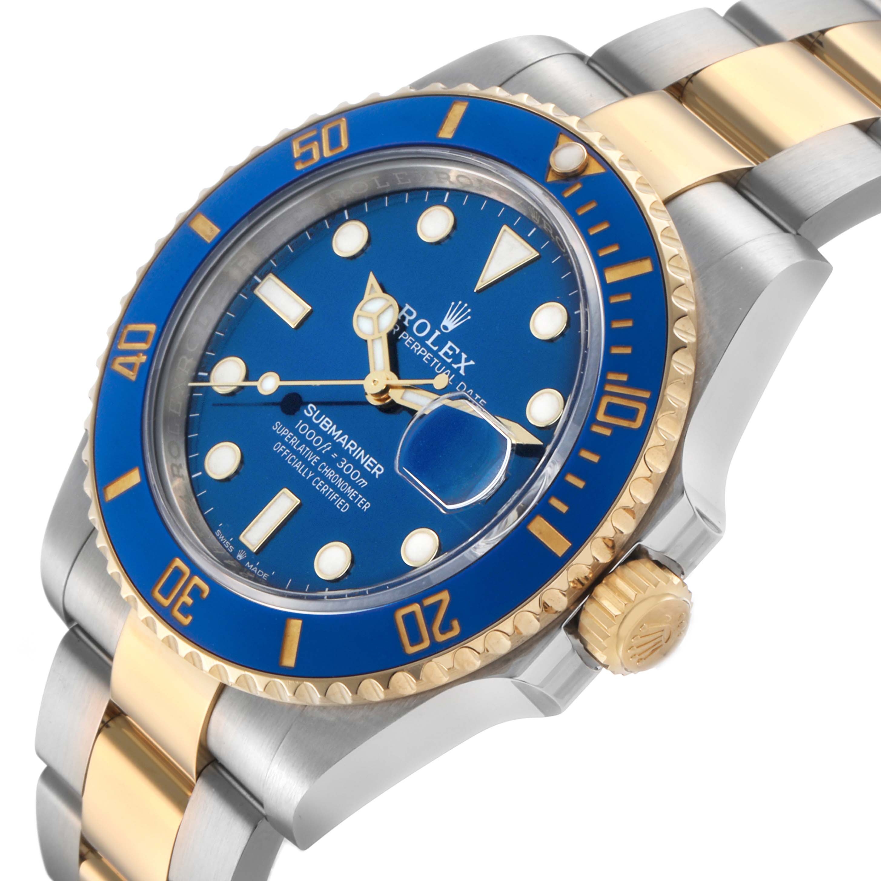 The Rolex Submariner 126613 Men's Steel and Gold (two tone) Blue Dial watch is shown at a side angle, highlighting the blue dial, bezel, crown, and two-tone bracelet.
