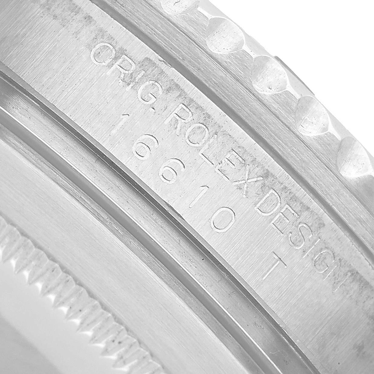 The image shows a close-up of the engraved side of a Rolex Submariner 16610 Men's Stainless Steel Black Dial, displaying the model number 16610.