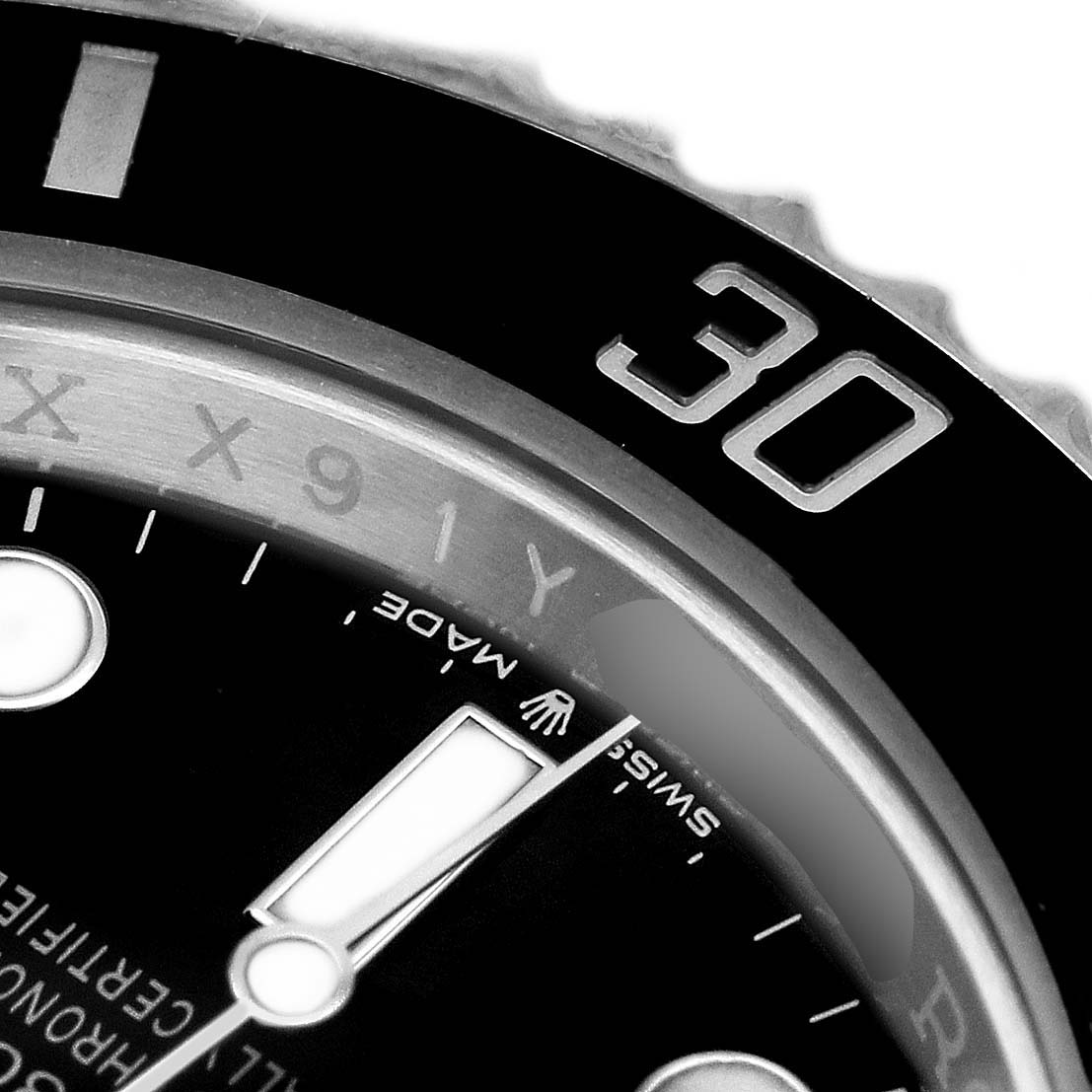 The image shows a close-up of the Rolex Submariner 124060 Men's Stainless Steel Black Dial bezel at the 30-minute mark and part of the dial with the "Swiss Made" text.
