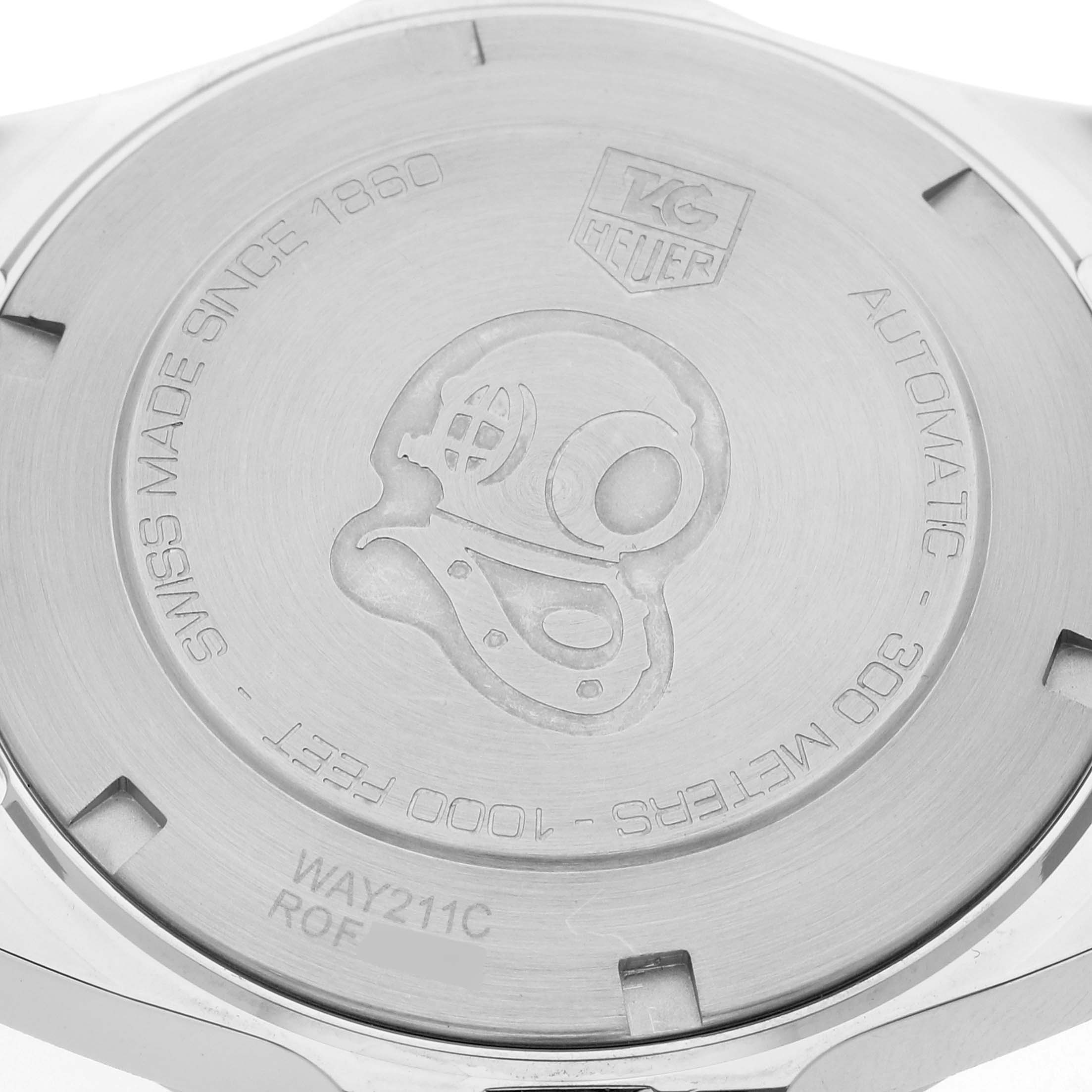 The image shows the case back of a Tag Heuer Aquaracer WAY211C.BA0928 Men's Stainless Steel Blue Dial WAY211C.BA0928 Men's Stainless Steel Blue Dial watch featuring engravings, including a diver's helmet.