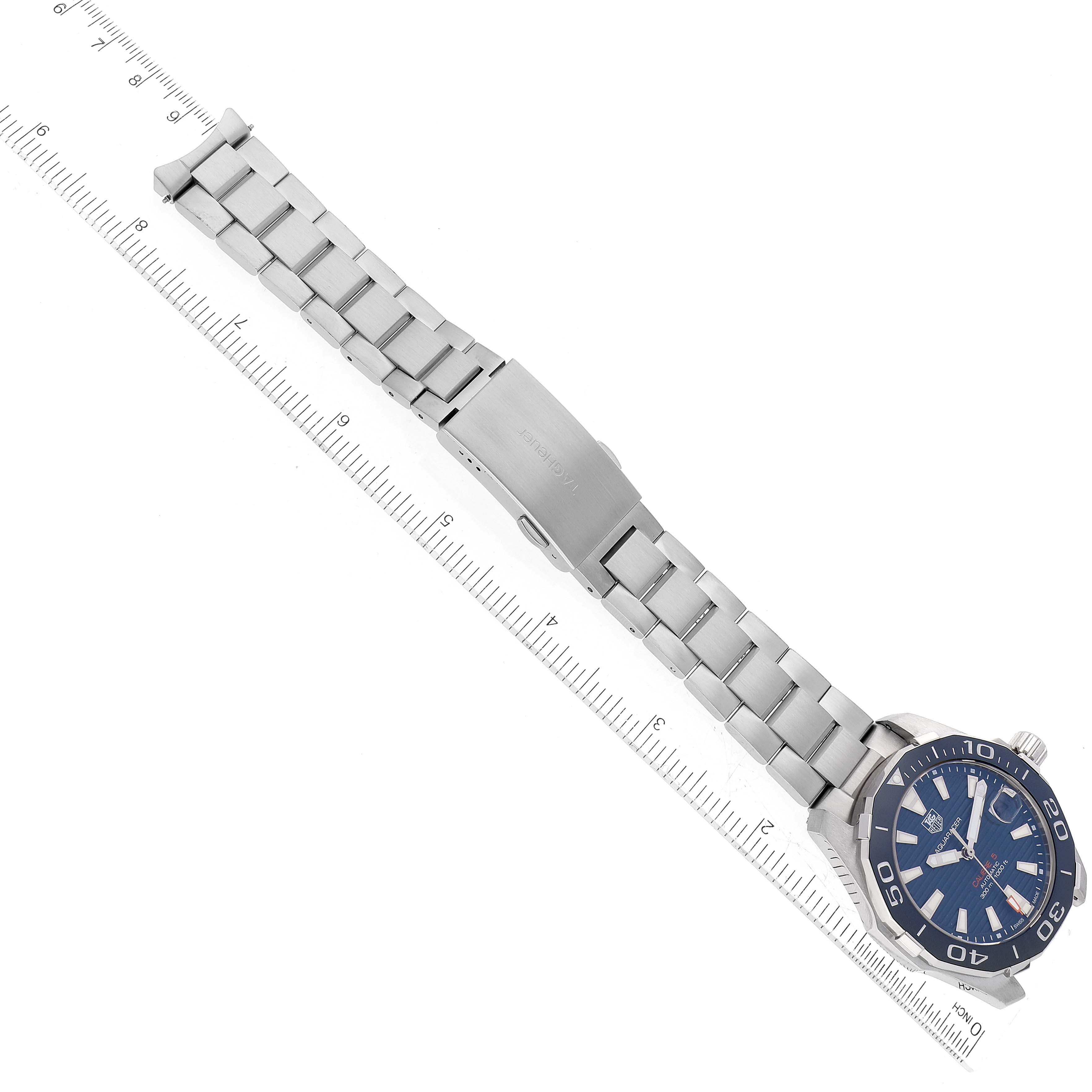 The image shows the Tag Heuer Aquaracer WAY211C.BA0928 Men's Stainless Steel Blue Dial WAY211C.BA0928 Men's Stainless Steel Blue Dial watch, featuring the full bracelet, clasp, and watch face, laying flat against a ruler for scale.