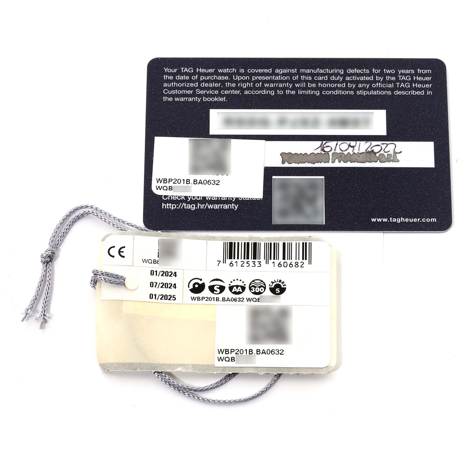 The image shows the warranty card and tags for a Tag Heuer Aquaracer WBP201B.BA0632 Men's Stainless Steel Blue Dial WBP201B.BA0632 Men's Stainless Steel Blue Dial model, placed flat on a surface.