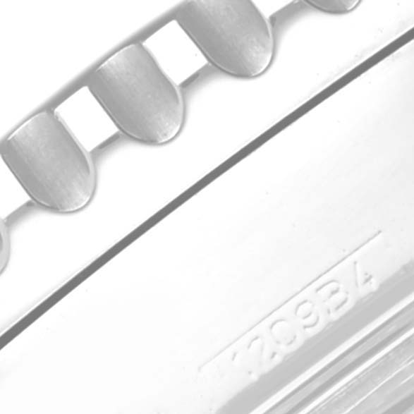 The image shows a close-up of the ridged bezel edge and part of the serial number of a Breitling Navitimer A23322 Men's Stainless Steel Black Dial A23322 Men's Stainless Steel Black Dial watch.