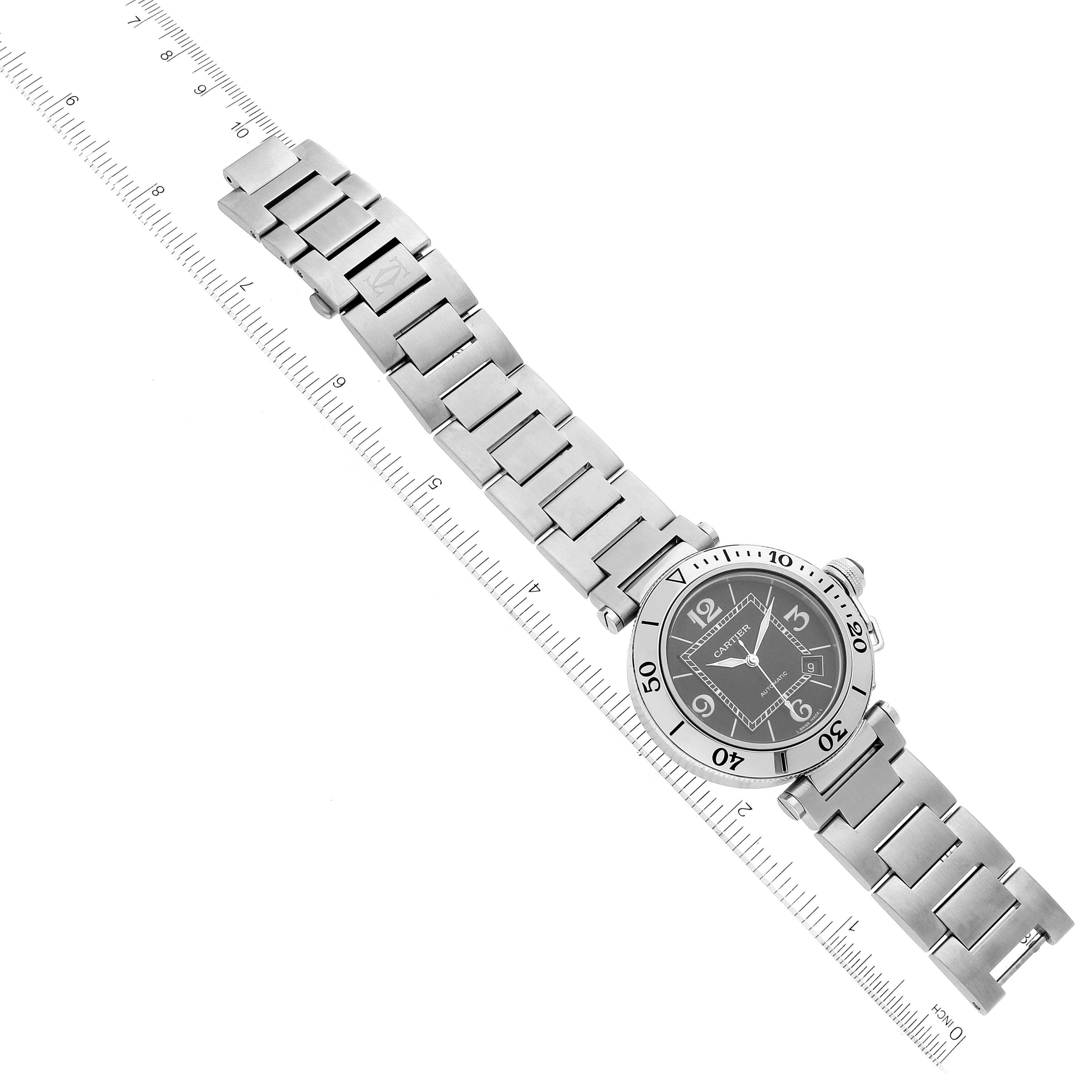 The image shows a Cartier Pasha W31077M7 Men
s Stainless Steel Black Dial W31077M7 Men
s Stainless Steel Black Dial watch fully extended with its face and bracelet visible from a top-down angle.