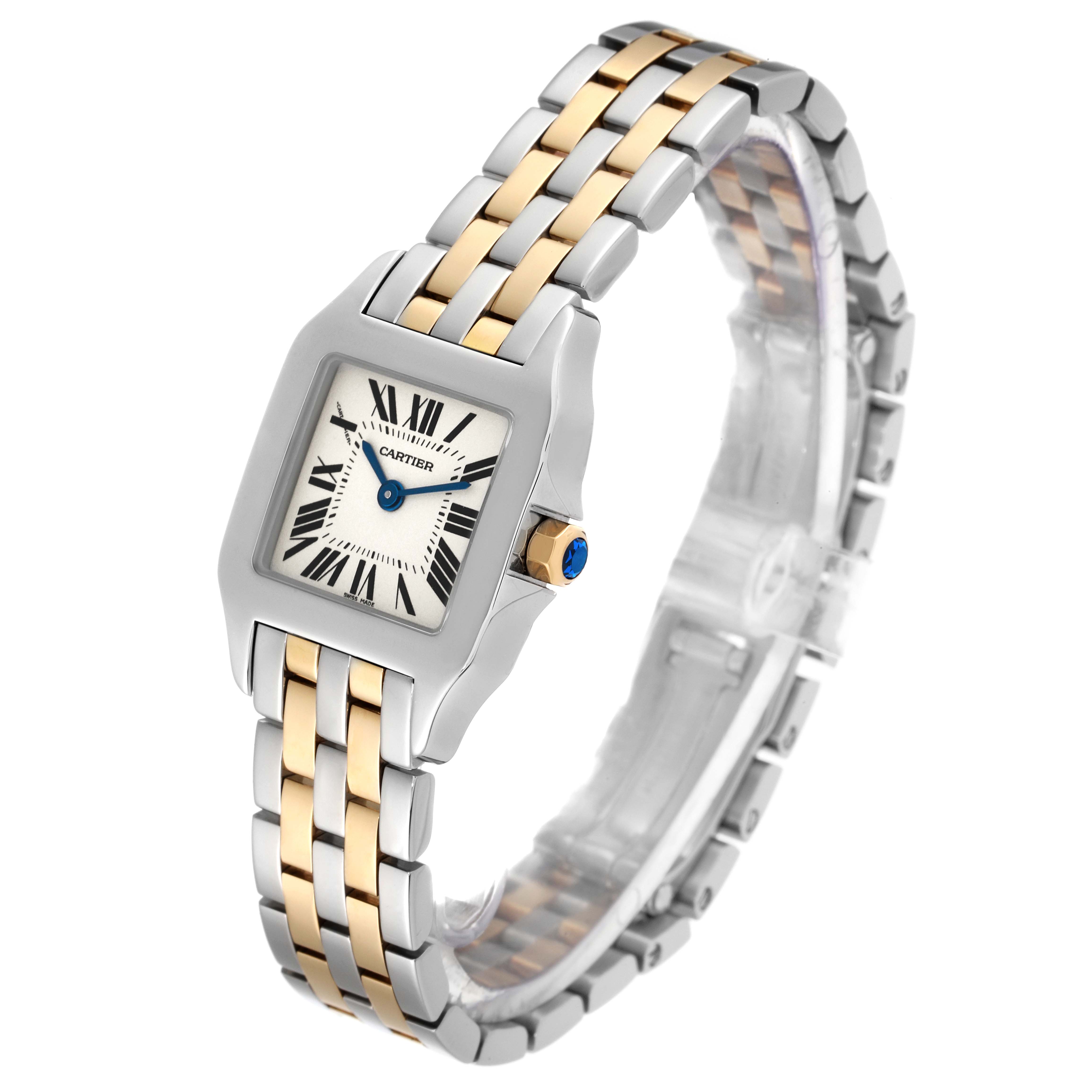 The Cartier Santos Demoiselle W25066Z6 Women
s Steel and Gold (two tone) Silver Dial W25066Z6 Women
s Steel and Gold (two tone) Silver Dial watch is shown at an angle highlighting the two-tone band, dial, and blue crown.