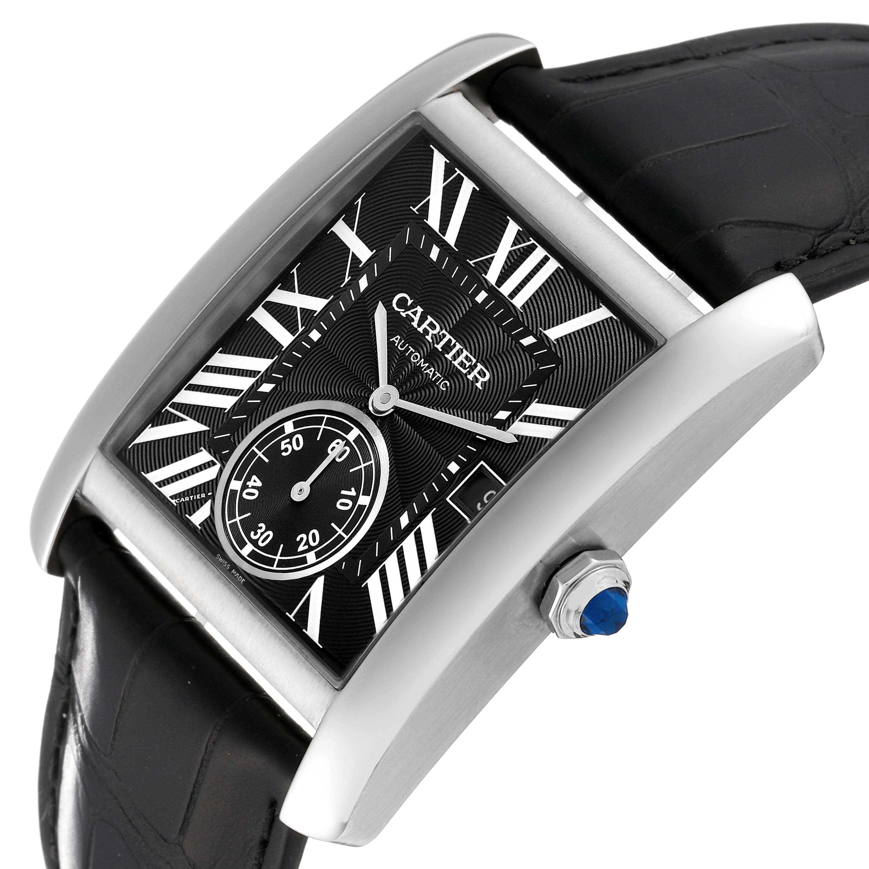 The image shows a Cartier Tank MC W5330004 Men
s Stainless Steel Black Dial W5330004 Men
s Stainless Steel Black Dial watch at an oblique angle displaying its black dial, Roman numerals, and blue cabochon crown.