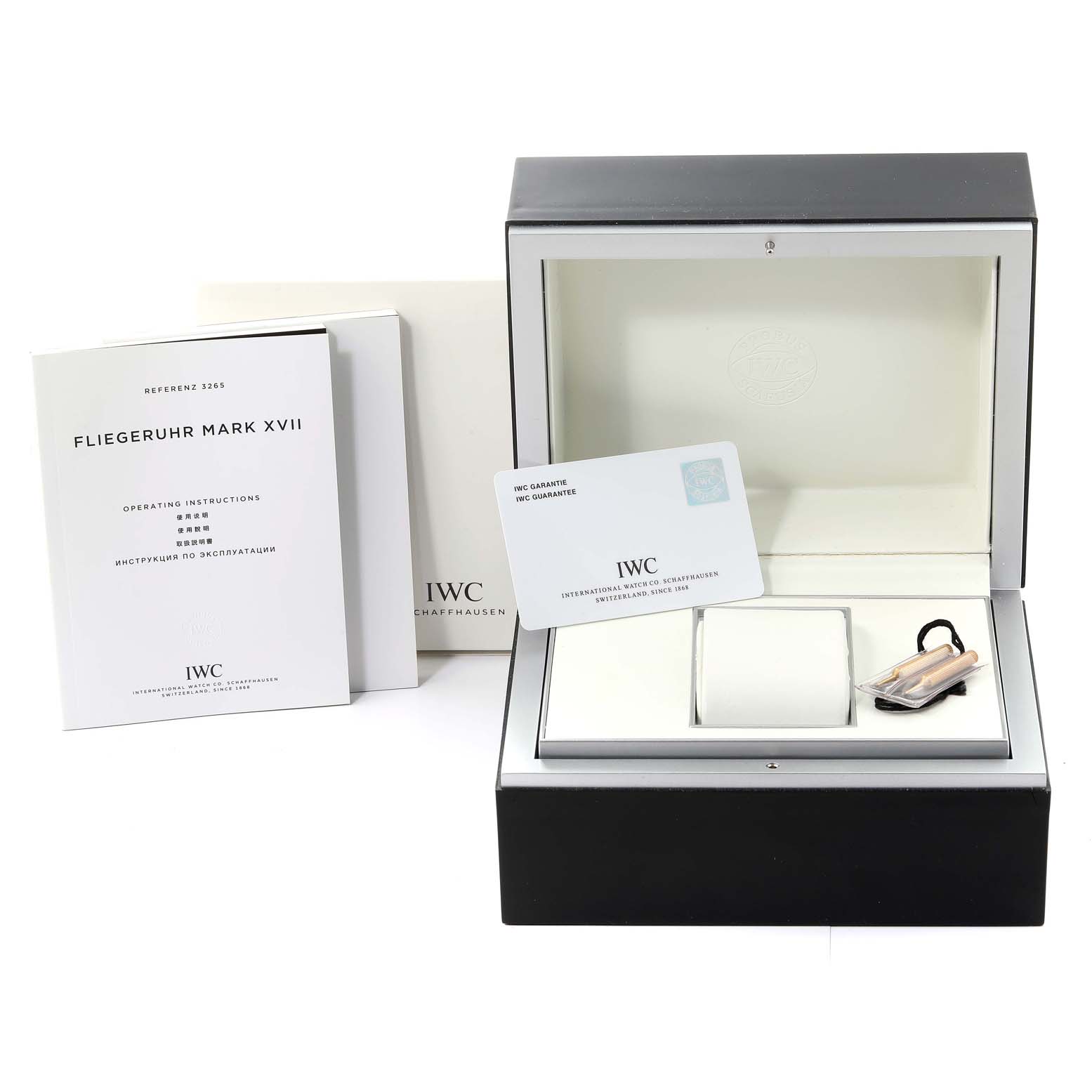 The image shows an IWC Pilot IW326504 Men's Stainless Steel Black Dial IW326504 Men's Stainless Steel Black Dial watch model box, instruction manuals, warranty card, pillow, and accessories from a front angle.