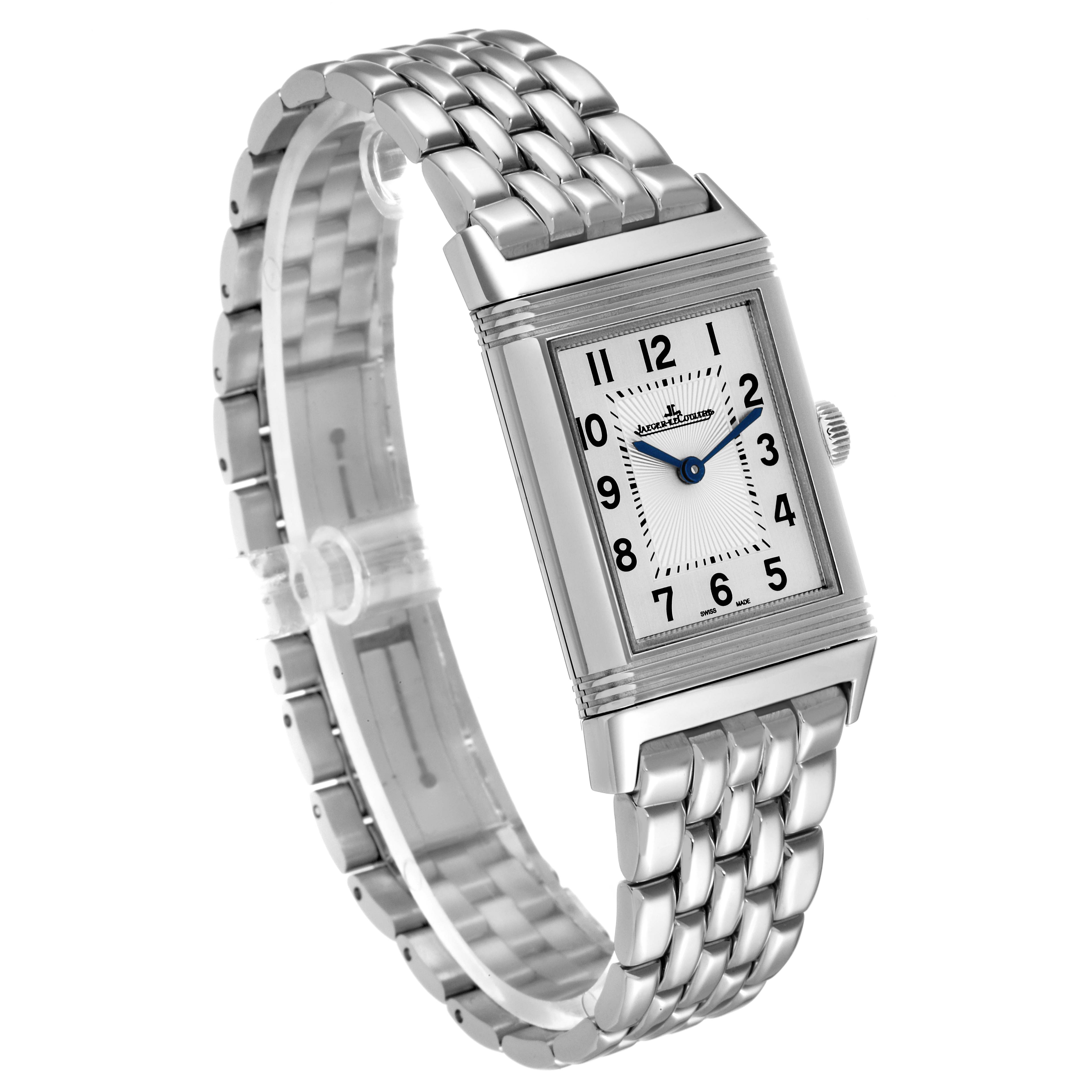 The image shows a partial top-front view of a Jaeger-LeCoultre Reverso watch, highlighting its rectangular face and metal link bracelet.