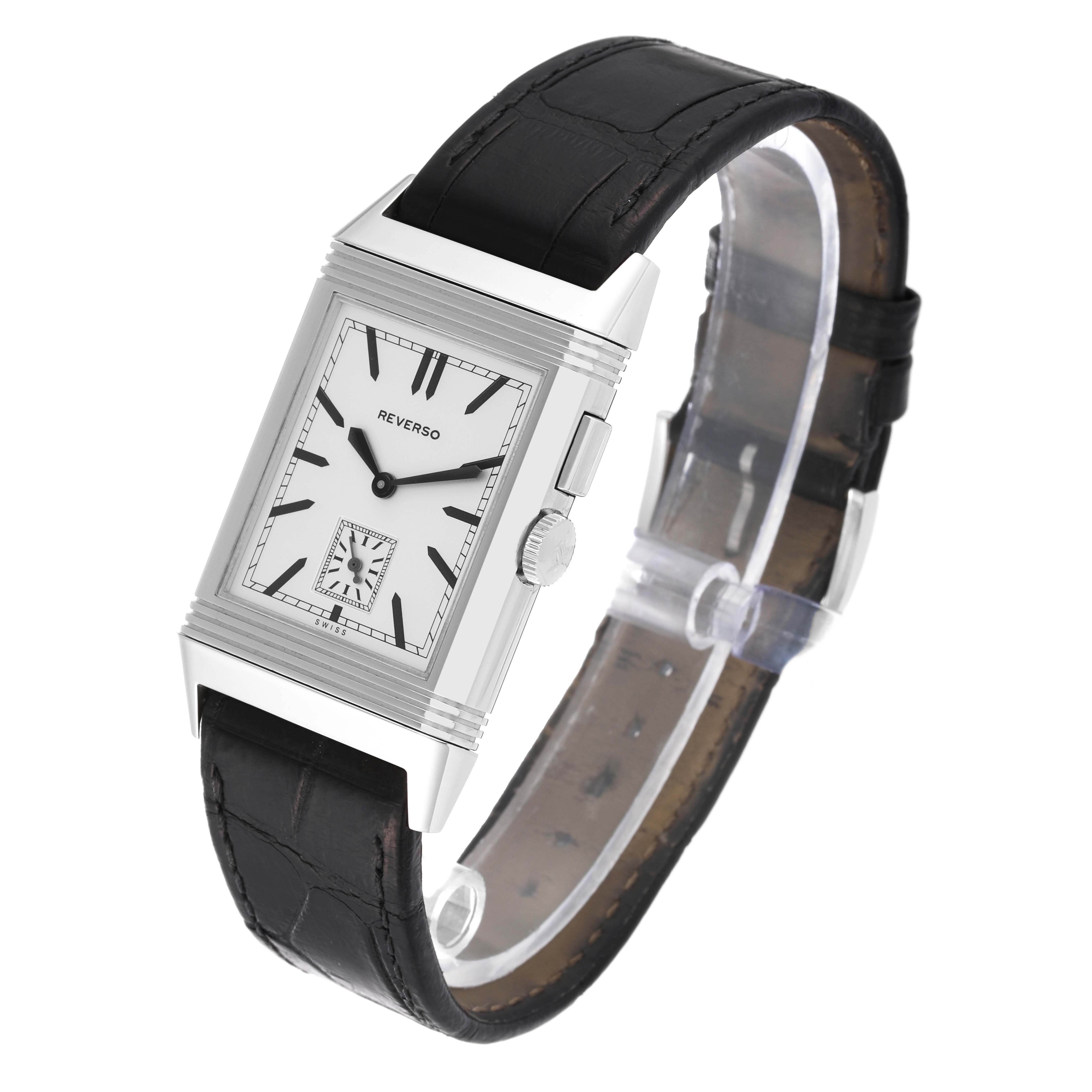 The Jaeger-LeCoultre Reverso watch is shown at a slight angle, highlighting its rectangular face, crown, and black leather strap.