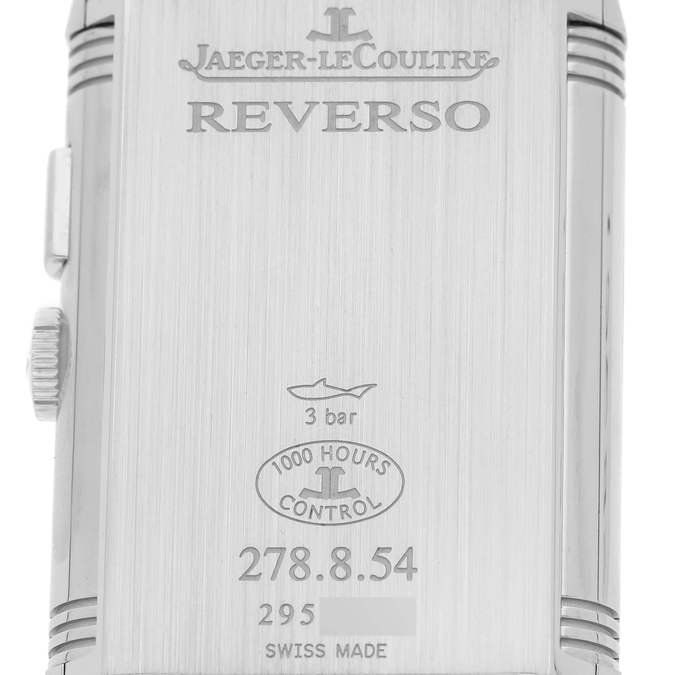 The image shows the back casing of a Jaeger-LeCoultre Reverso watch, detailing its model number, water resistance, and certification.