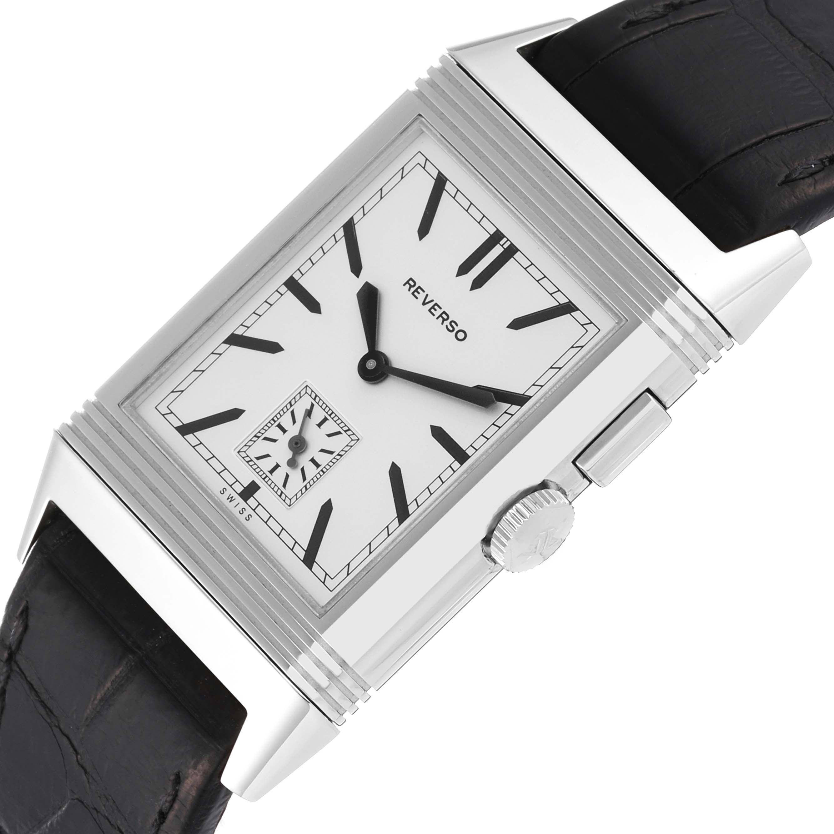 The image shows a close-up angle of the silver dial, crown, and part of the black strap of the Reverso model by Jaeger LeCoultre.