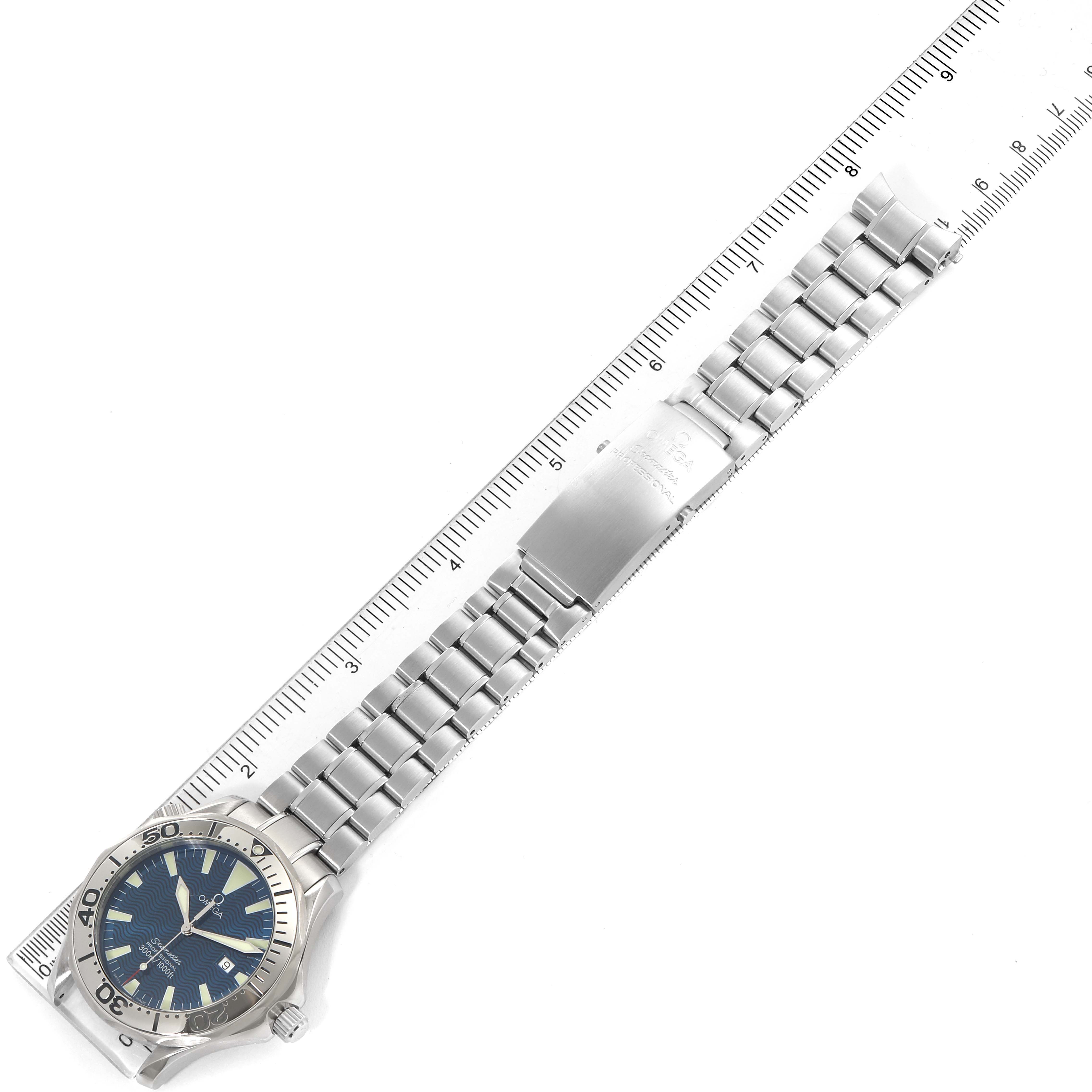 The image shows an Omega Seamaster 2265.80.00 Men
s Stainless Steel Blue Dial 2265.80.00 Men
s Stainless Steel Blue Dial watch with a metal bracelet, laid flat next to a ruler for scale.