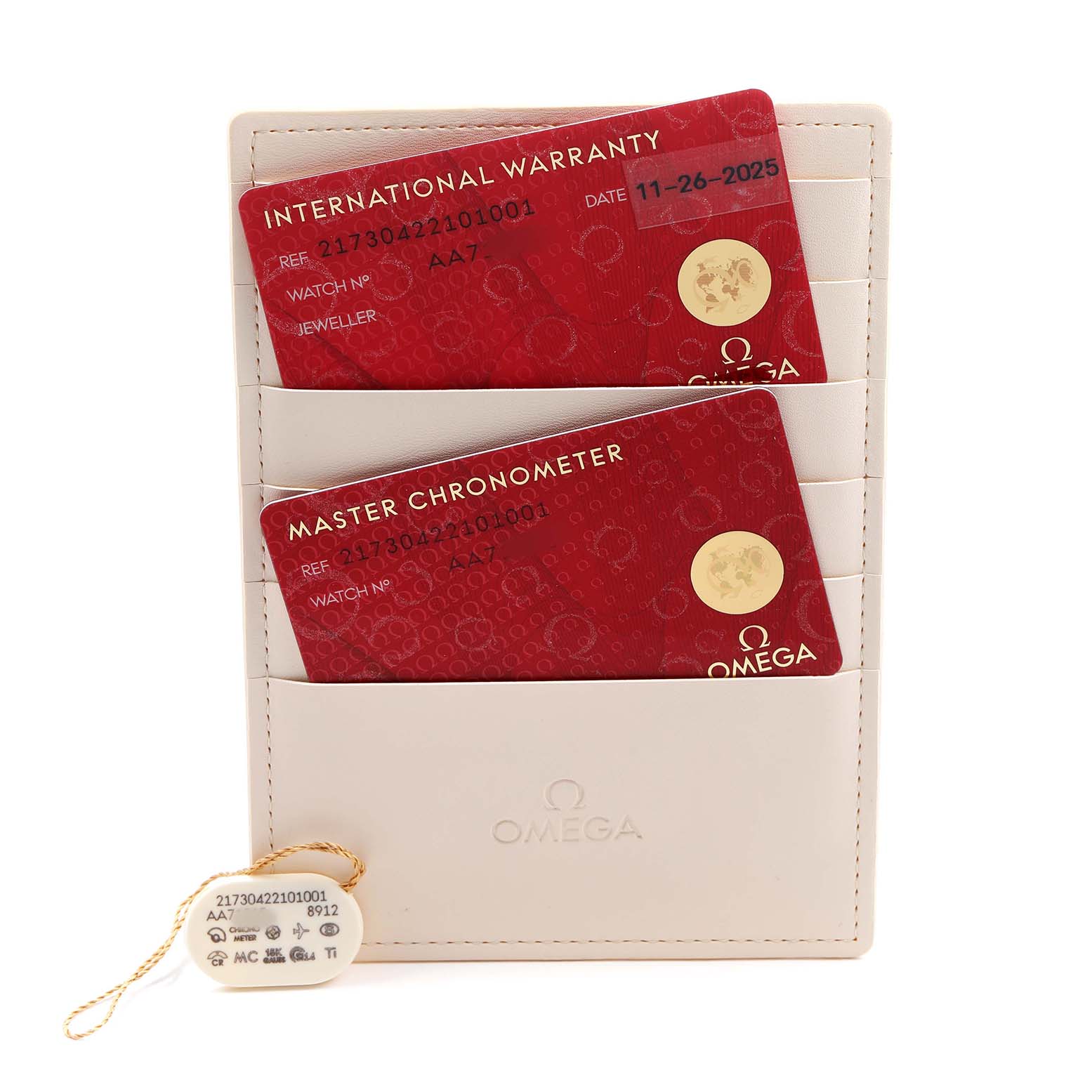 The image shows Omega Seamaster 217.30.42.21.01.001 Men's Stainless Steel Black Dial watch accessories including warranty cards and a tag, viewed from a top angle.