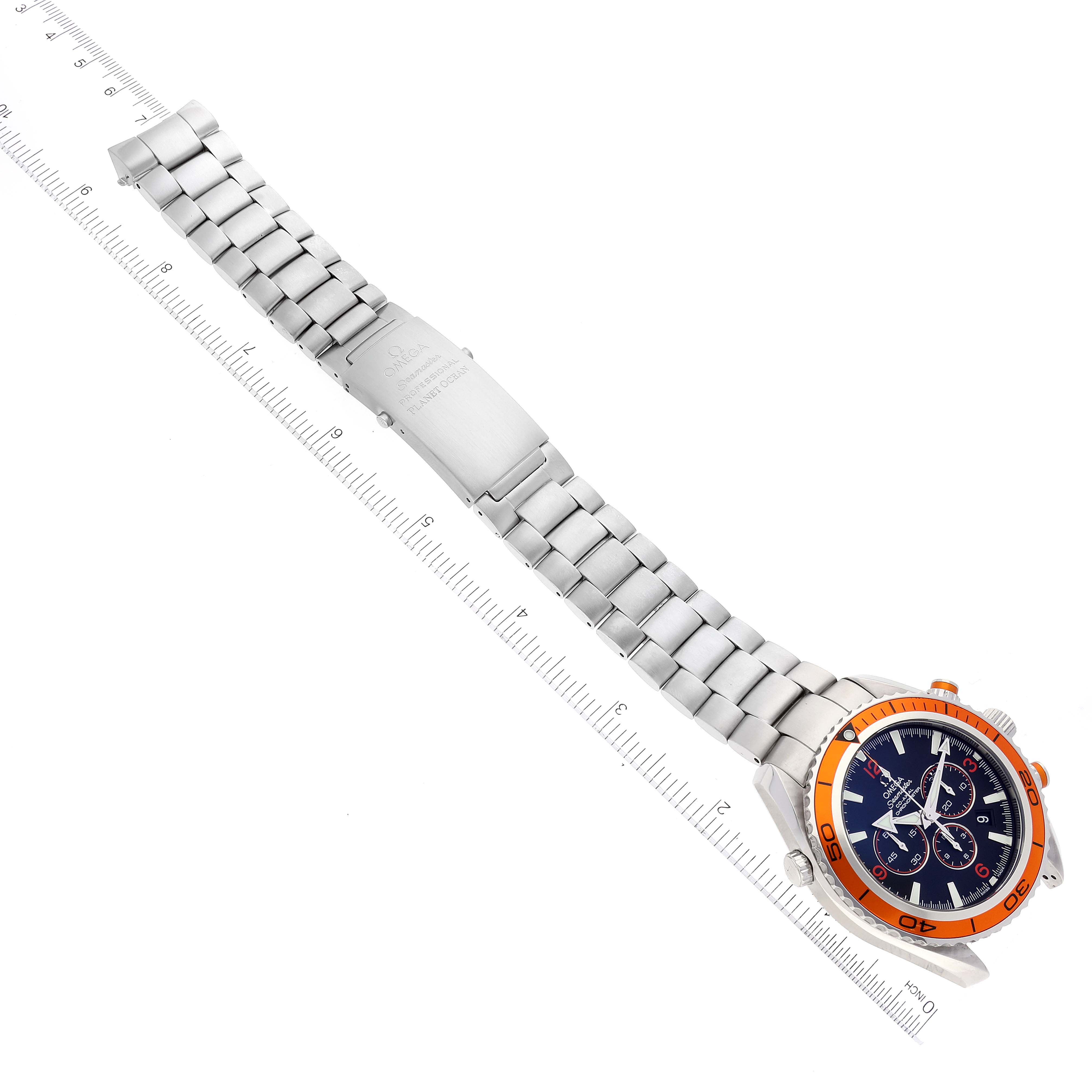 The Omega Planet Ocean 2218.50.00 Men
s Stainless Steel Black Dial 2218.50.00 Men
s Stainless Steel Black Dial watch is displayed flat, showcasing its dial, bezel, and stainless steel bracelet, with a ruler for scale.