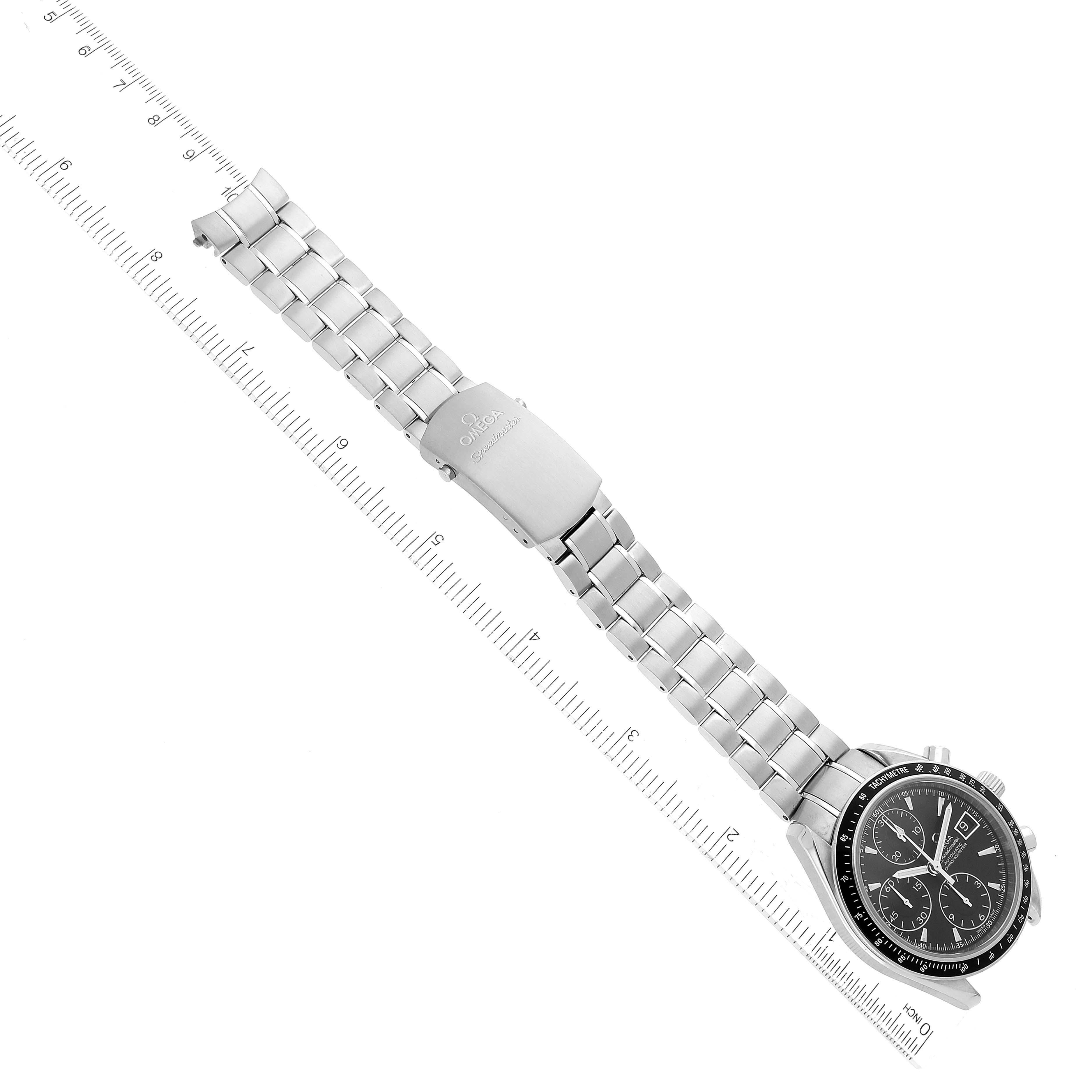 The Omega Speedmaster 3210.50.00 Men
s Stainless Steel Black Dial 3210.50.00 Men
s Stainless Steel Black Dial watch is shown laid flat with its face, bracelet, and clasp visible, aligned next to a ruler.