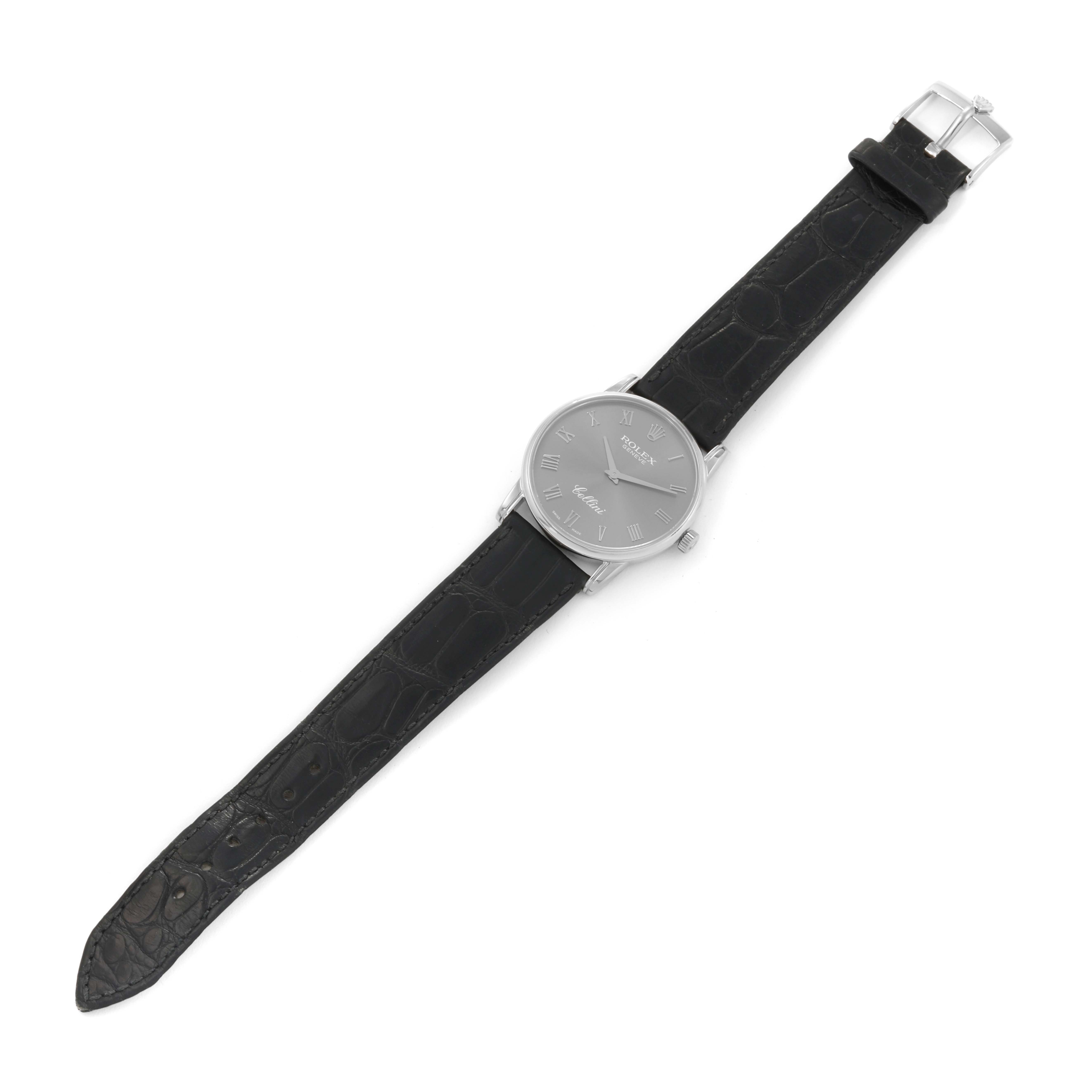 The image shows a full view of a Rolex Cellini 5116/9 Men's White Gold Grey Dial 5116/9 Men's White Gold Grey Dial watch, featuring its black leather strap, silver case, and dial.