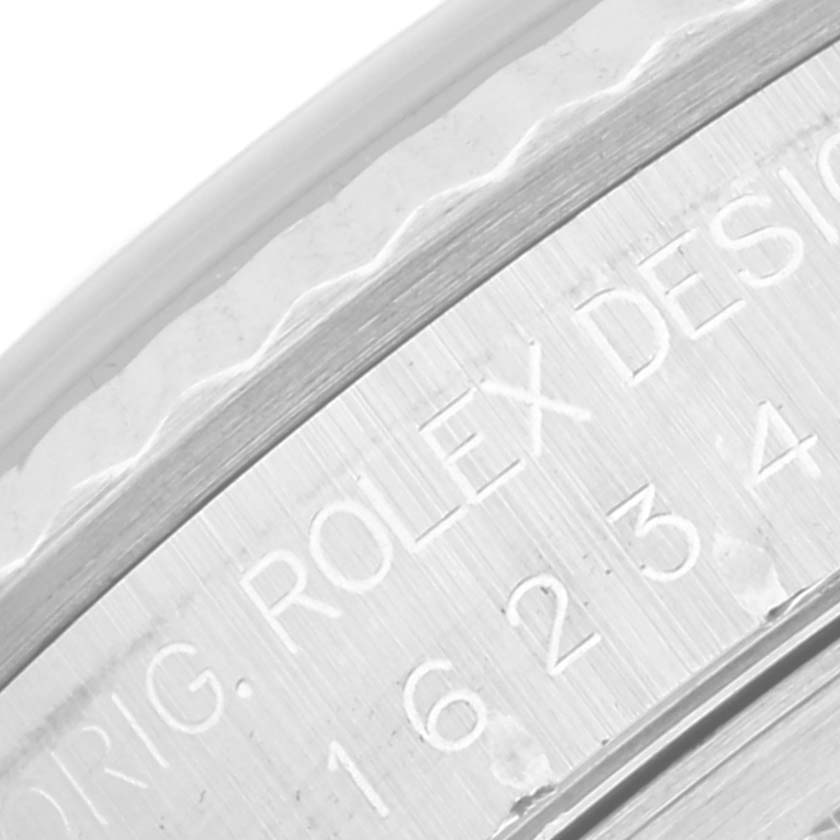 The image shows a close-up view of the case back engraving of the Rolex Datejust 16234 Men's Stainless Steel Blue Dial 16234 Men's Stainless Steel Blue Dial watch.