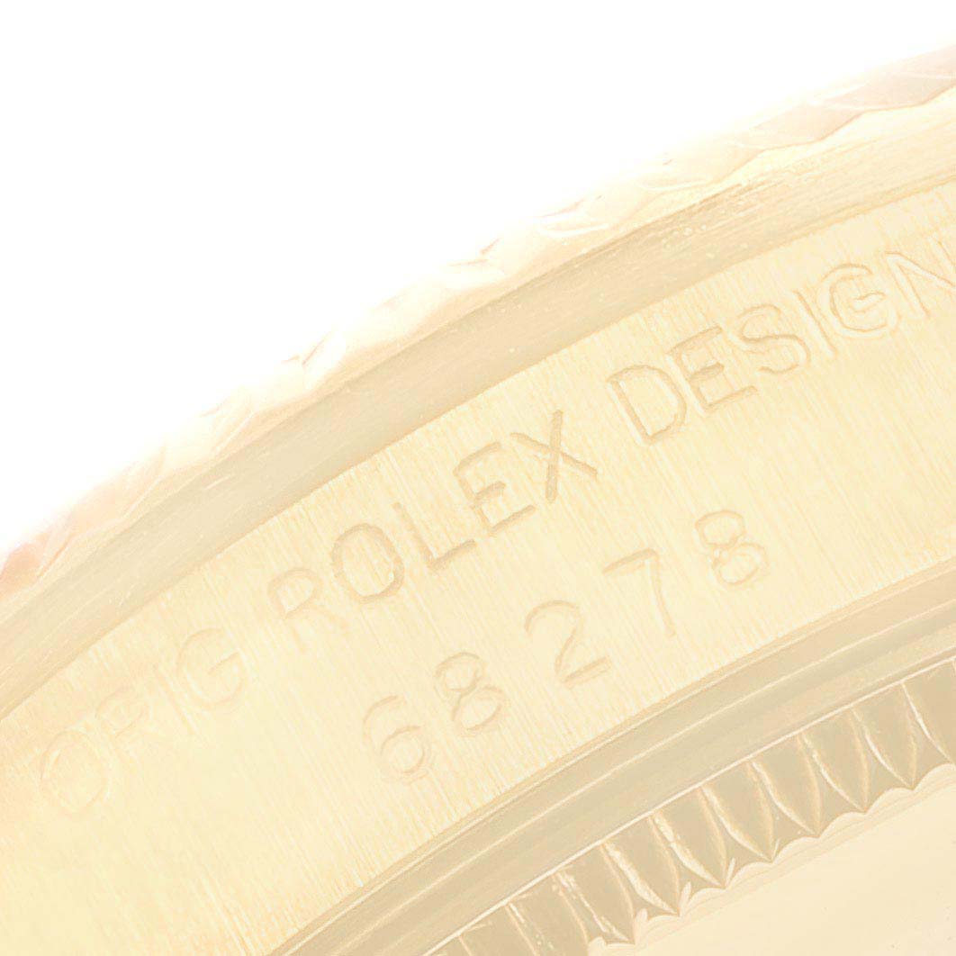 The image shows a close-up of the case edge of a Rolex President 68278 Women
s Yellow Gold White Dial 68278 Women
s Yellow Gold White Dial model, highlighting the engraved text and part of the bezel.