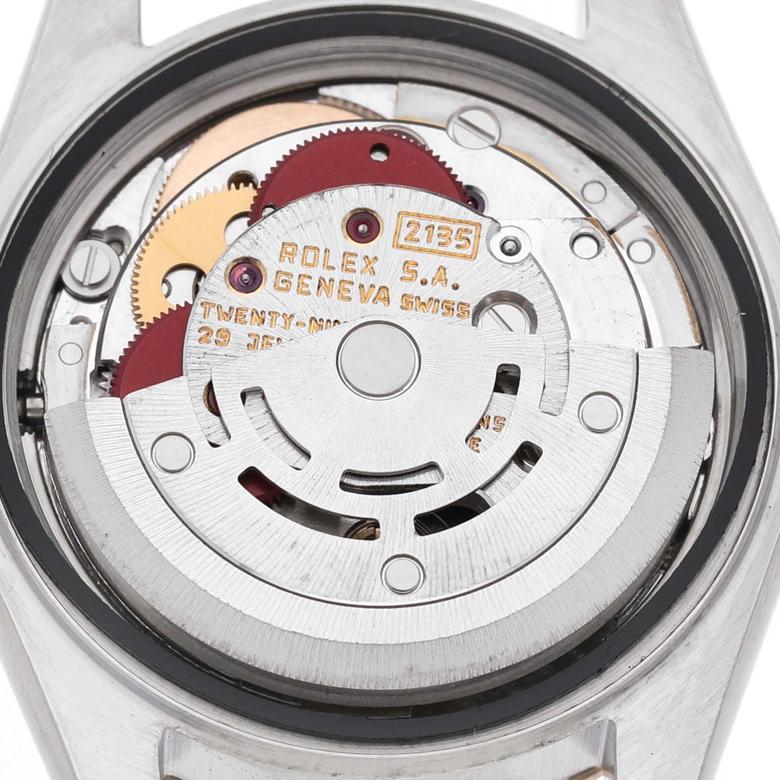 The image shows the movement of a Rolex Datejust 69173 Women's Steel and Gold (two tone) Silver Dial, viewed from the back, revealing gears and inscriptions.