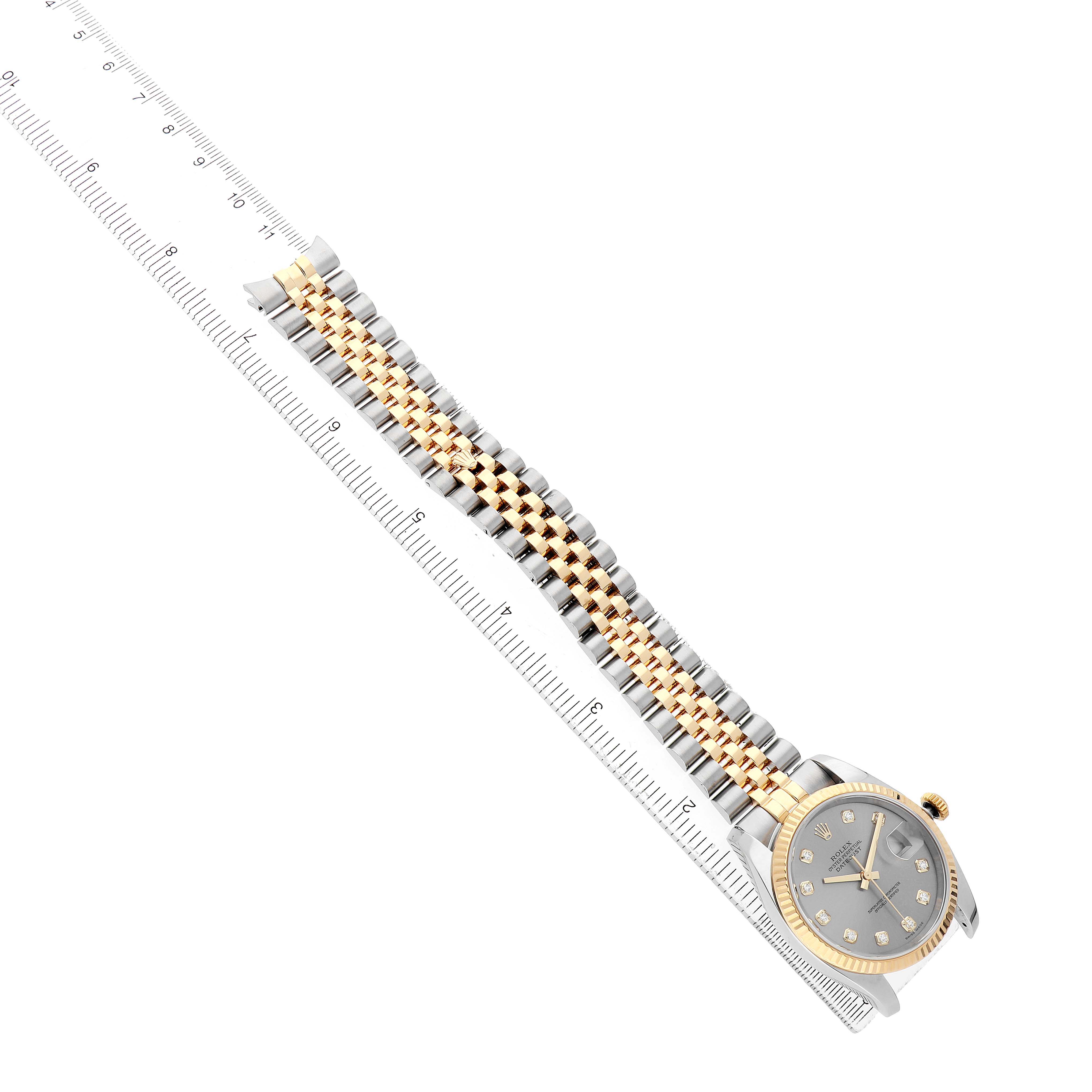 The Rolex Datejust 116233 Men's Steel and Gold (two tone) Grey Dial watch is shown at an oblique angle, highlighting its dial, bezel, and bracelet alongside a ruler.