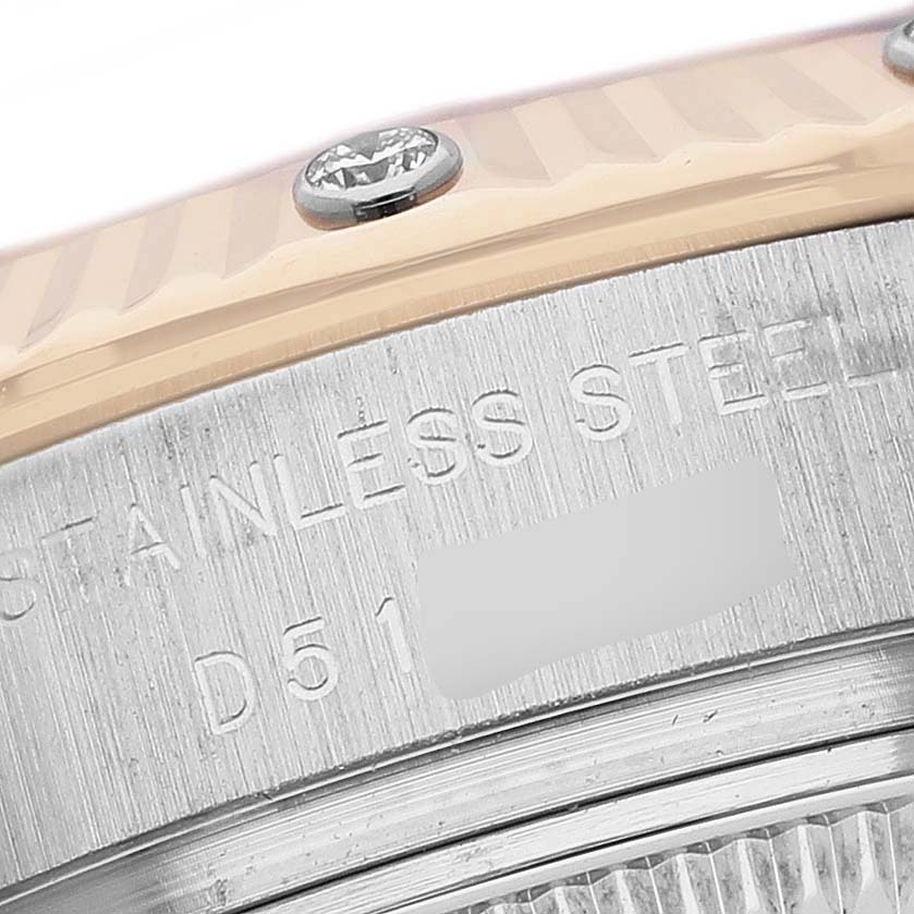 The image shows a close-up of the side of a Rolex Datejust 179313 Women's Steel and Gold (two tone) Mother of Pearl Dial bezel with an engraved serial number and part of the case.