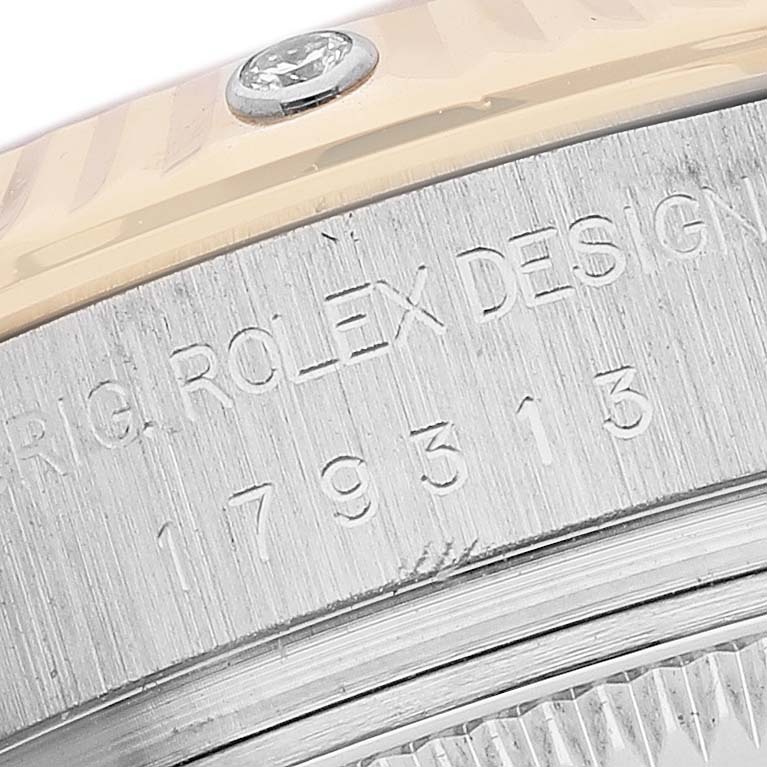 The image shows a close-up of the Rolex Datejust 179313 Women's Steel and Gold (two tone) Mother of Pearl Dial model's engraved side, highlighting the model number and design details.