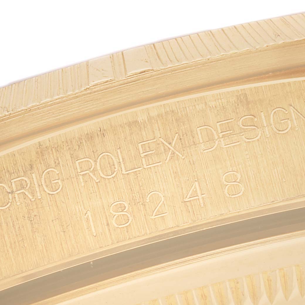 This close-up image shows the engraved text on the side of the bezel of a Rolex President 18248 Men
s Yellow Gold Champagne Dial 18248 Men
s Yellow Gold Champagne Dial model watch.
