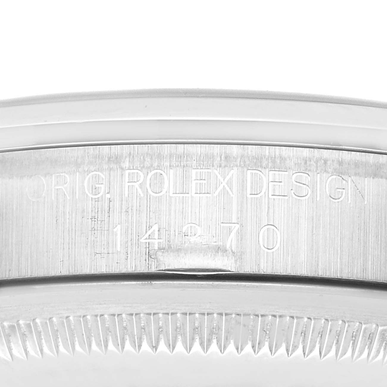 This close-up image shows the engraved side of the watch case of a Rolex Explorer 14270 Men
s Stainless Steel Black Dial 14270 Men
s Stainless Steel Black Dial model.