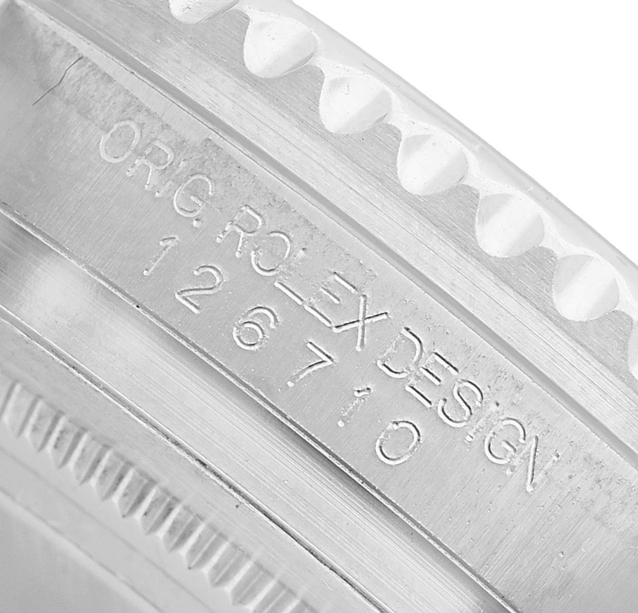 The image shows a close-up of the Rolex GMT-Master 126710BLNR Men's Stainless Steel Black Dial bezel with engraved text "ORIG ROLEX DESIGN 126710".