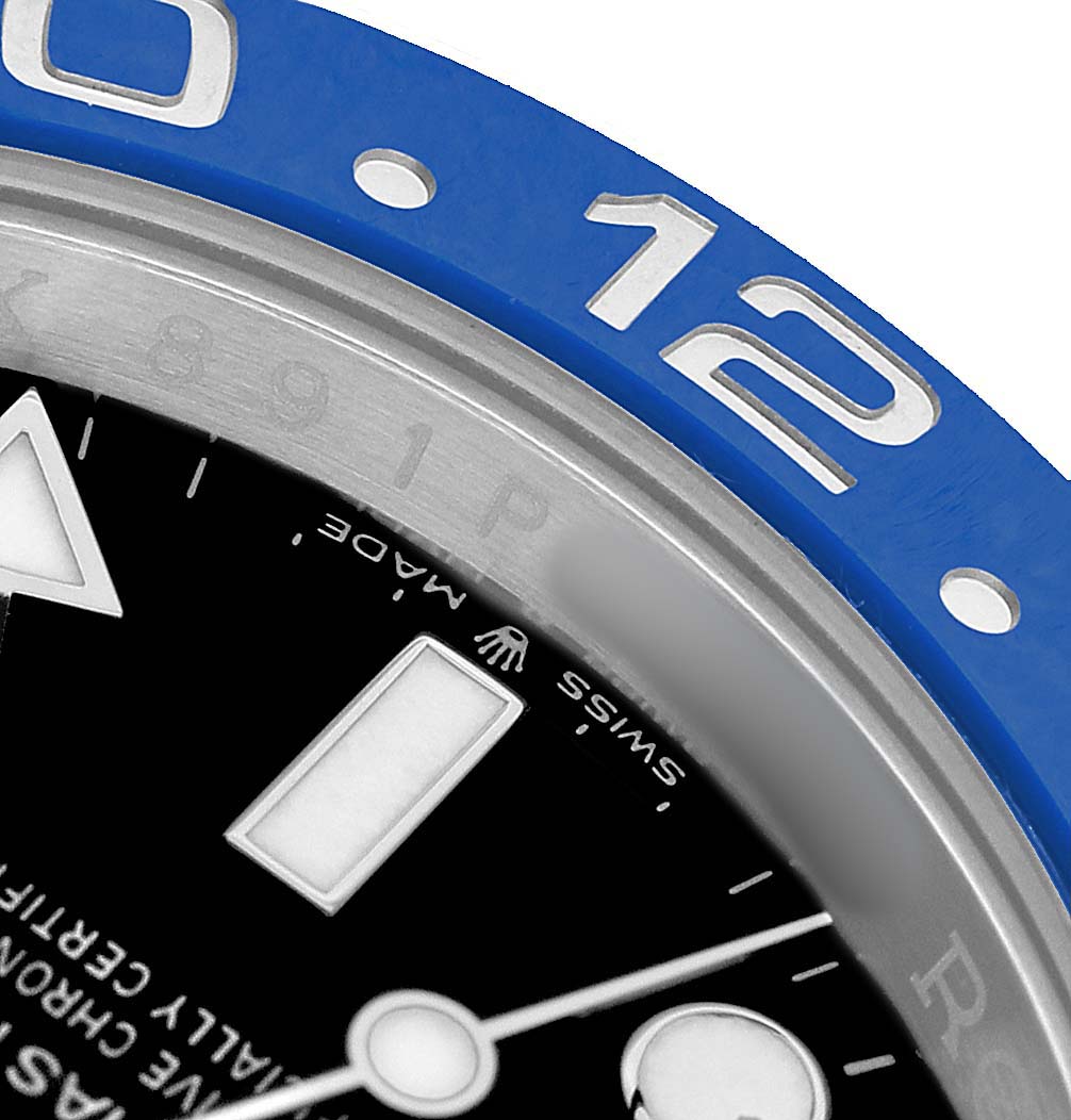 The image shows a close-up angle of the Rolex GMT-Master 126710BLNR Men's Stainless Steel Black Dial, highlighting the blue bezel, hour markers, and part of the dial.