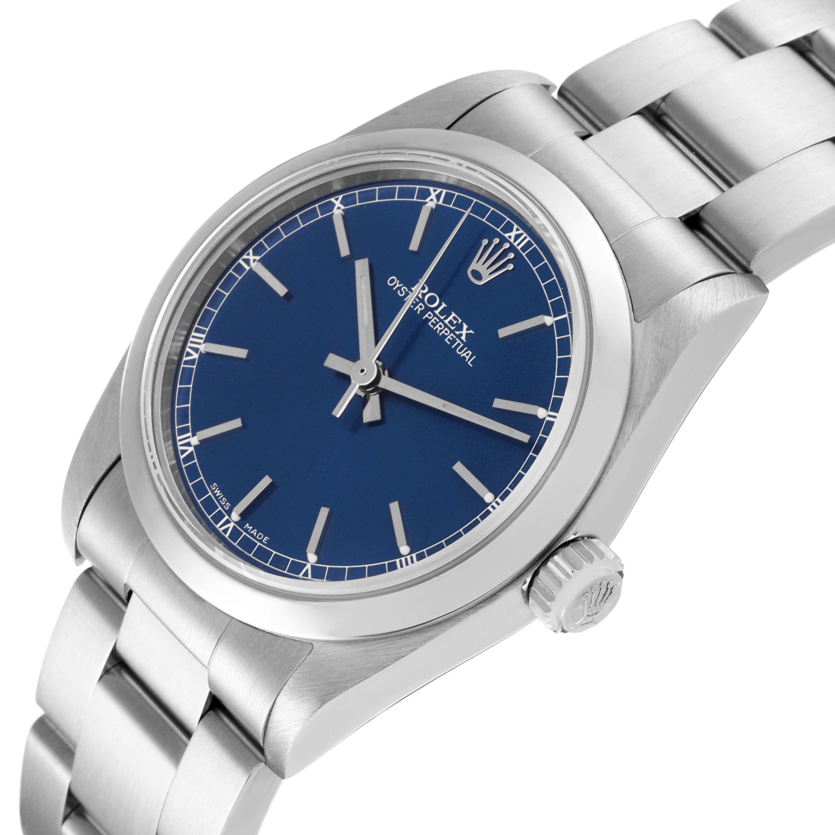 The image shows a top and side view of the Rolex Mid-Size 77080 Women
s Stainless Steel Blue Dial 77080 Women
s Stainless Steel Blue Dial model, displaying its blue dial, crown, and stainless steel bracelet.