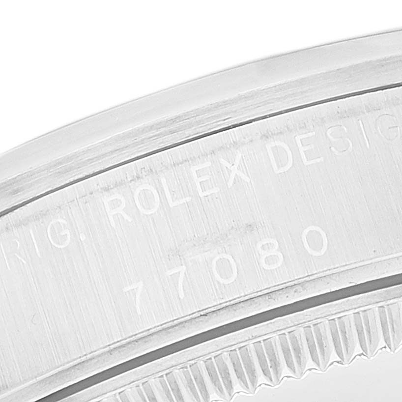 This close-up image shows the engraved serial number on the case of the Rolex Mid-Size 77080 Women
s Stainless Steel Blue Dial 77080 Women
s Stainless Steel Blue Dial model watch.