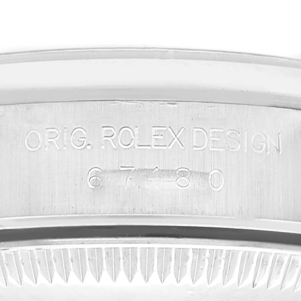 The image shows a close-up of the side engraving on a Rolex Oyster Perpetual 67180 Women's Stainless Steel Pink Dial 67180 Women's Stainless Steel Pink Dial watch case.