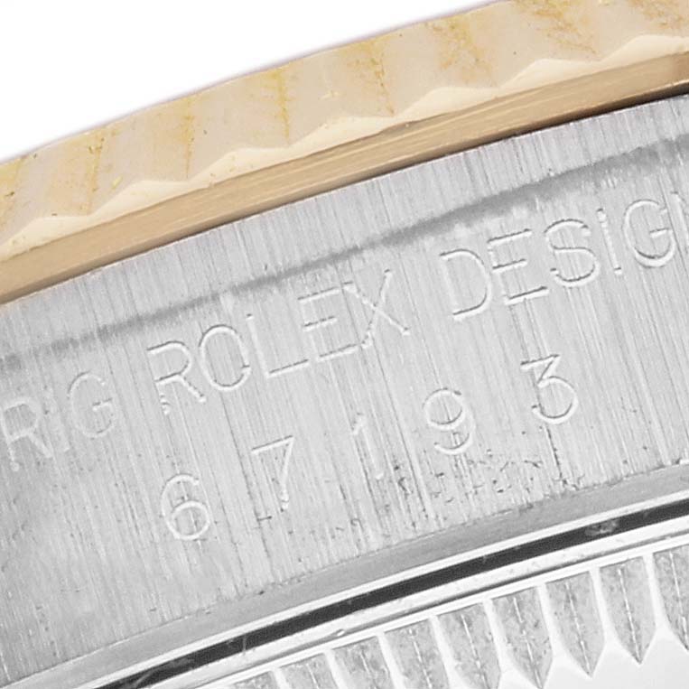 This image depicts a close-up of the engraved case back of a Rolex Oyster Perpetual M67193 Women's Steel and Gold (two tone) Champagne Dial M67193 Women's Steel and Gold (two tone) Champagne Dial watch, showing the model number 67193.