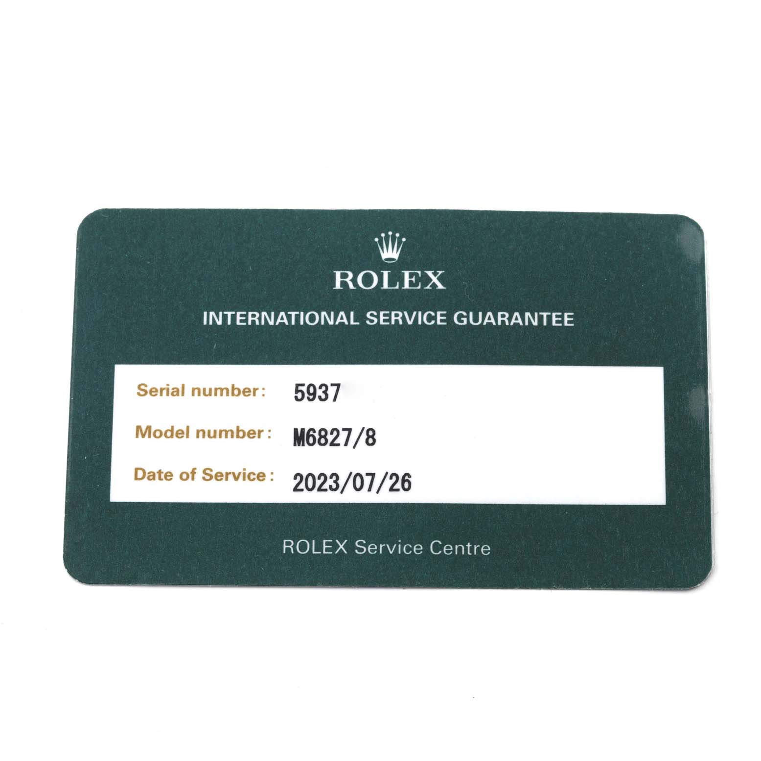 This image shows a Rolex President M6827/8 Women's Yellow Gold Champagne Dial M6827/8 Women's Yellow Gold Champagne Dial model international service guarantee card listing the serial and model numbers and date of service.