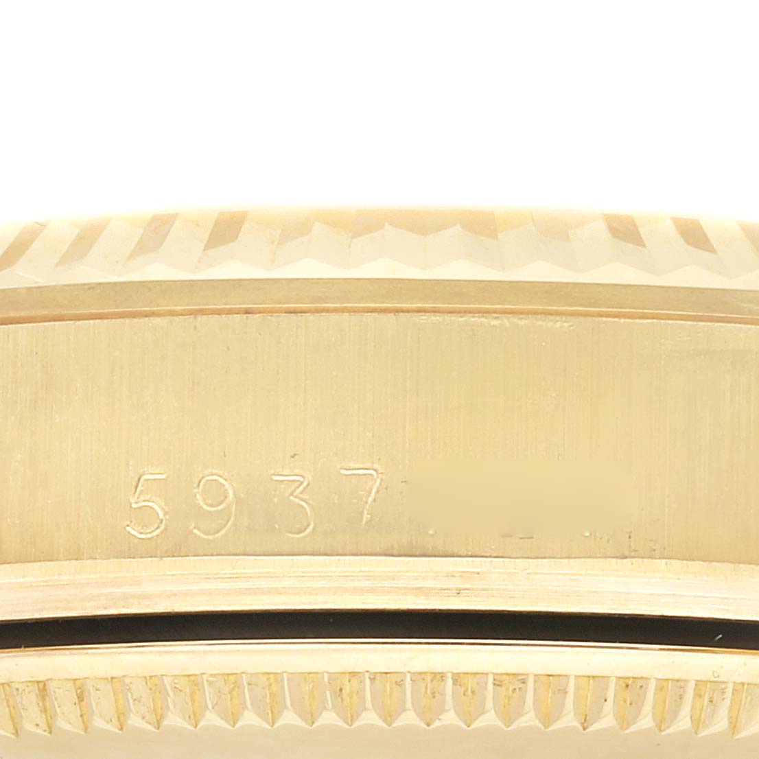 This image shows a close-up of the side of the case of a Rolex President M6827/8 Women's Yellow Gold Champagne Dial M6827/8 Women's Yellow Gold Champagne Dial model watch, revealing its serial number.