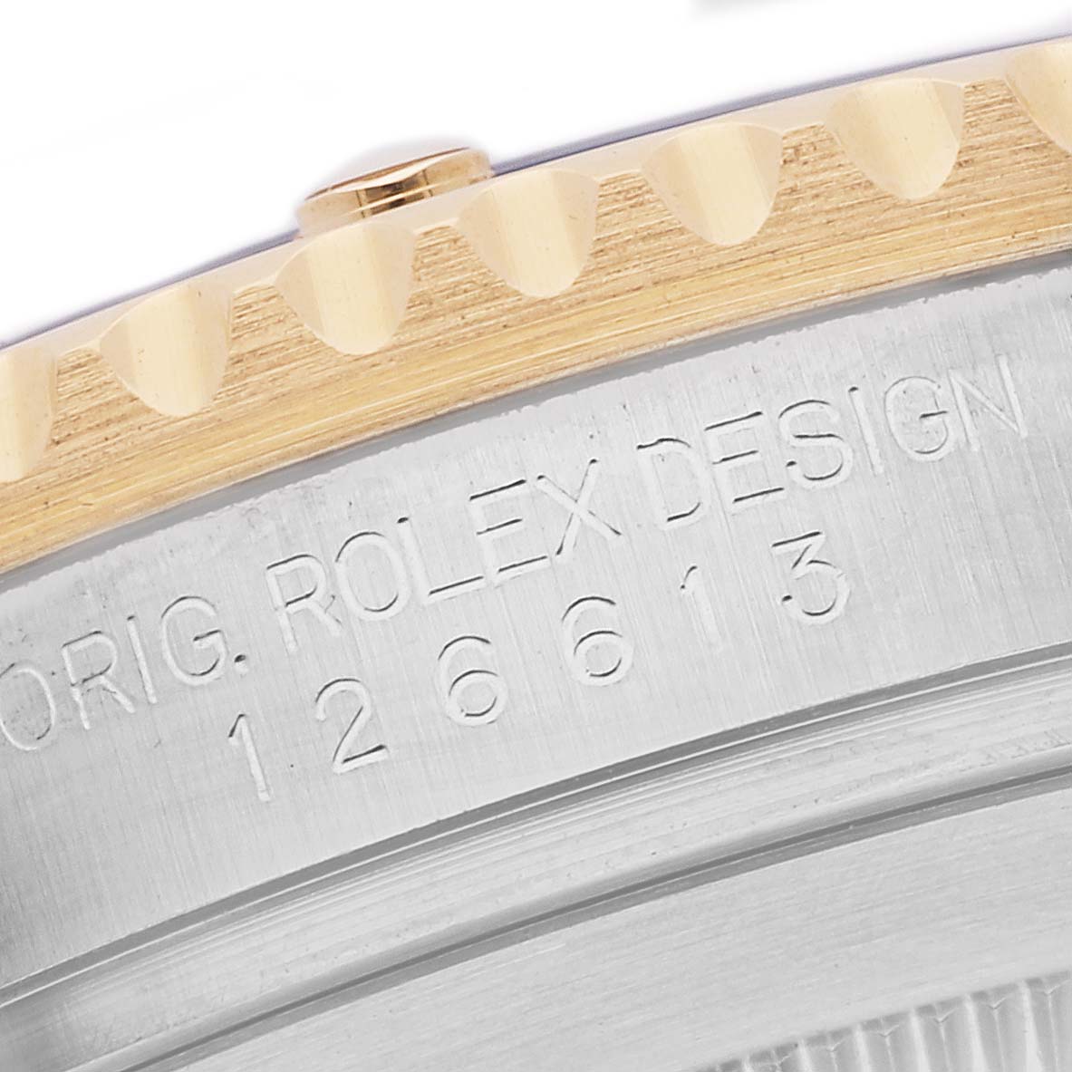 The image shows a close-up of the Rolex Submariner 126613LB Men's Steel and Gold (two tone) Blue Dial 126613LB Men's Steel and Gold (two tone) Blue Dial watch, focusing on the engraved bezel and partial case with model number 126613.