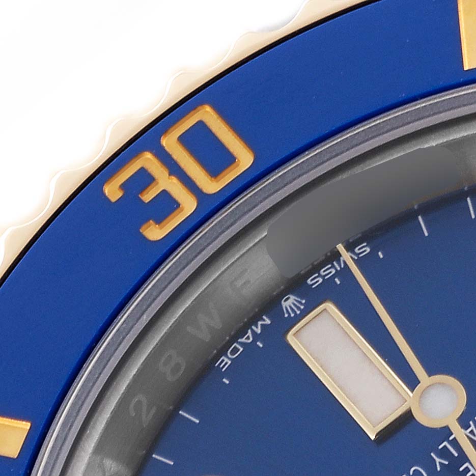 Close-up of the Rolex Submariner 126613LB Men's Steel and Gold (two tone) Blue Dial 126613LB Men's Steel and Gold (two tone) Blue Dial showing a portion of the blue bezel with the number 30 and part of the dial with minute markers.