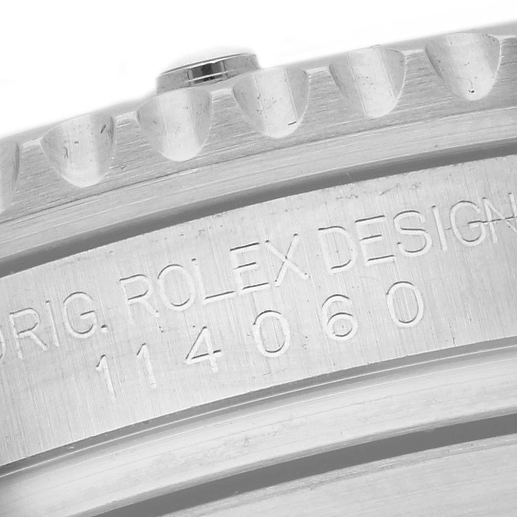 The image shows a close-up of the engraved serial number on the case side of a Rolex Submariner 114060 Men's Stainless Steel Black Dial 114060 Men's Stainless Steel Black Dial watch.